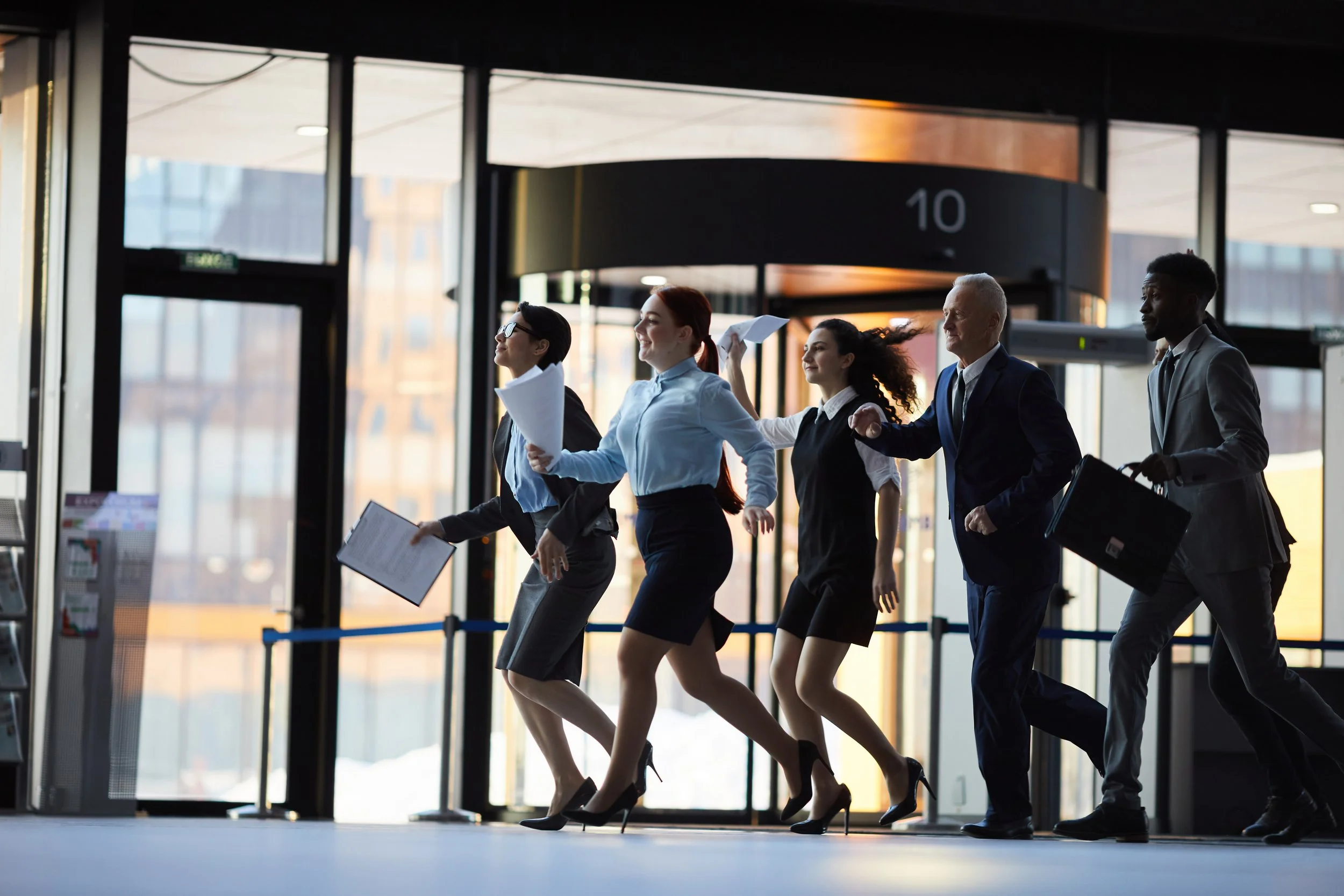 Business professionals walking through an airport — representing medium businesses with employees who need disability and travel coverage.