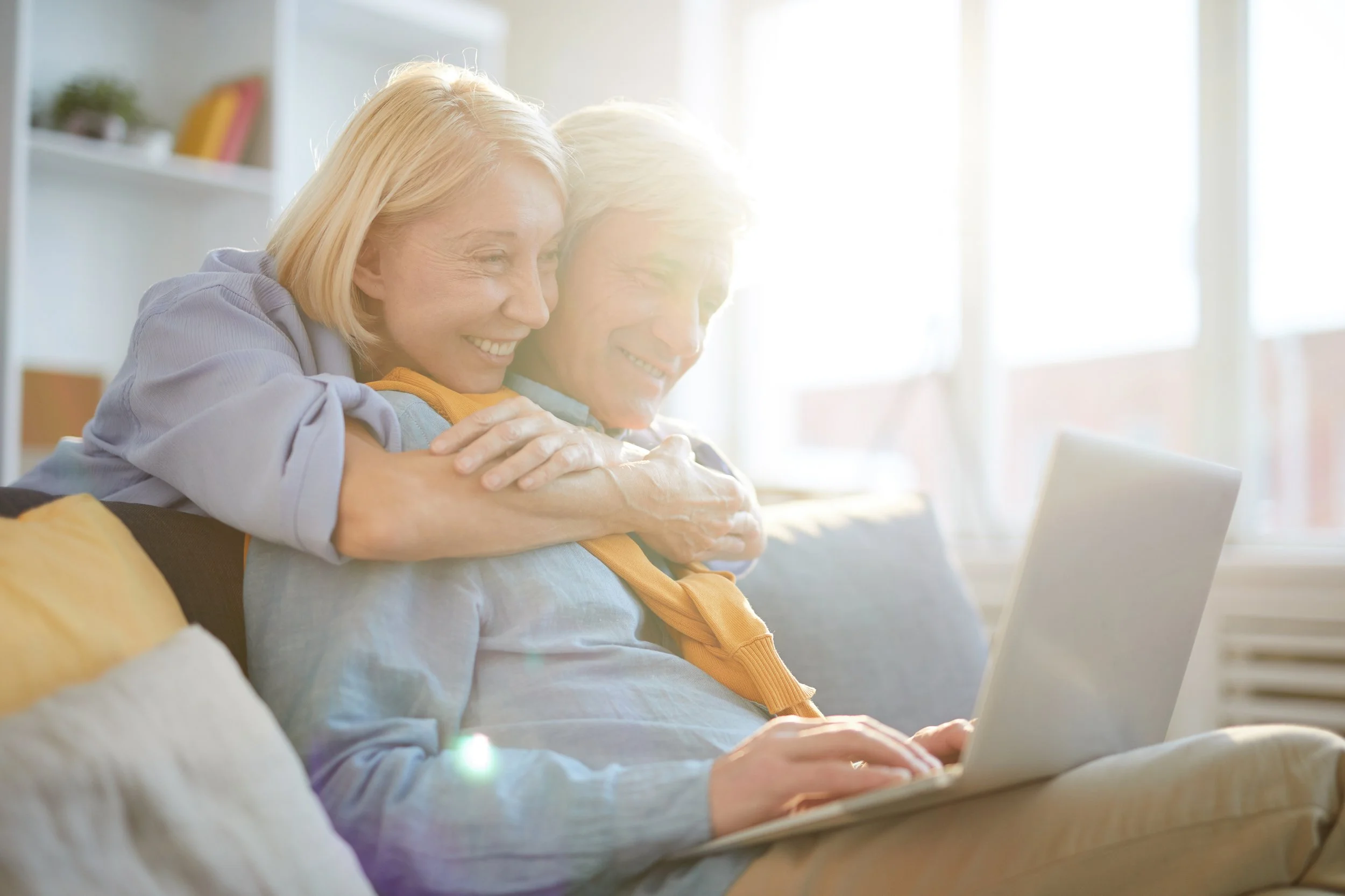 An elderly couple researching annuity options on their laptop, planning for stable retirement income and long-lasting financial security.