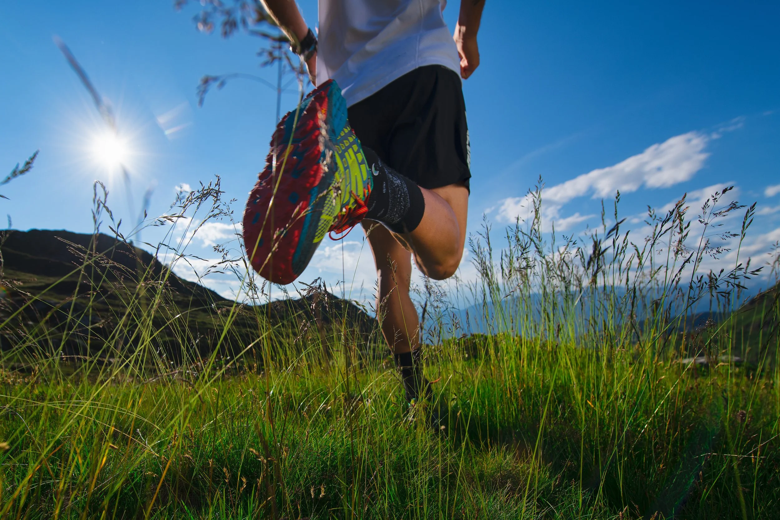 A person running along a mountain trail — representing the importance of critical illness insurance for maintaining financial stability during unexpected health challenges.