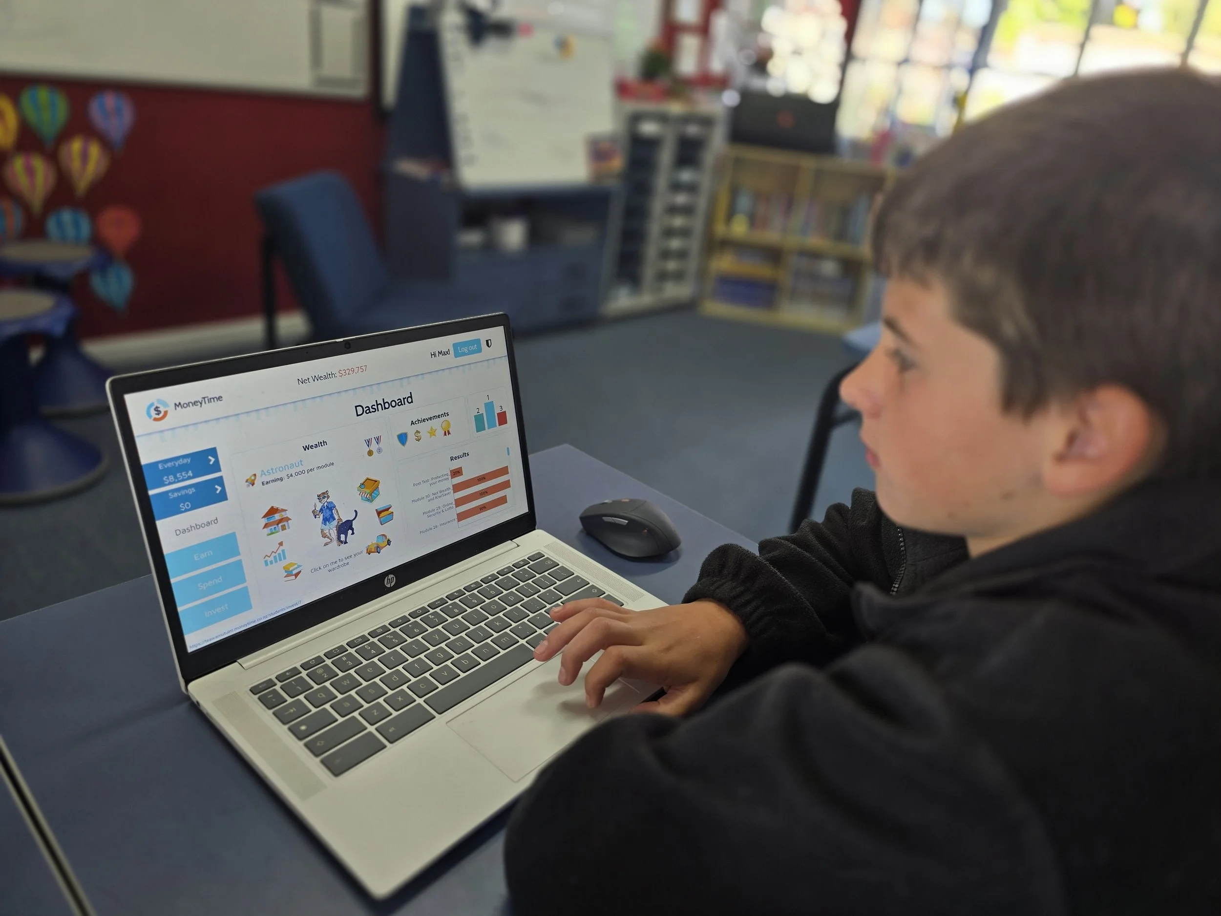 Boy doing MoneyTime on laptop
