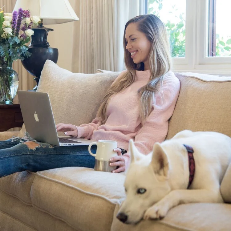 Kaitlin Breuninger working on a custom Squarespace website from her laptop