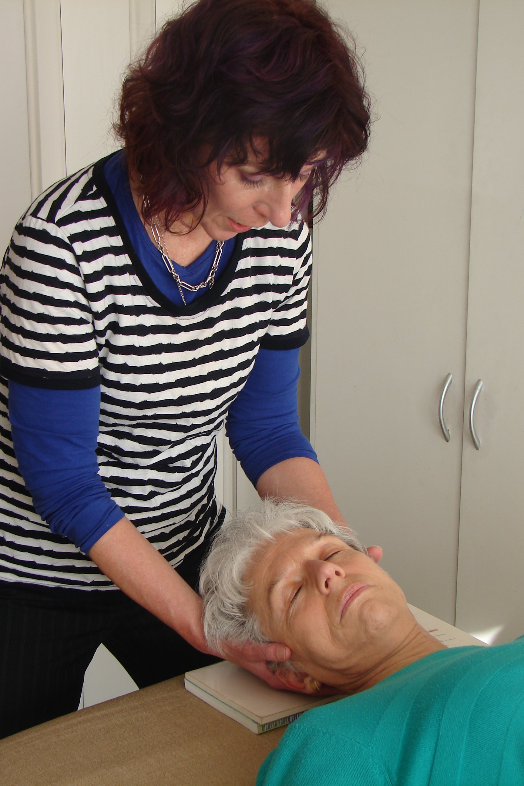 Maria McGivern, Alexander technique teacher, working with an Alexander technique student on the table.