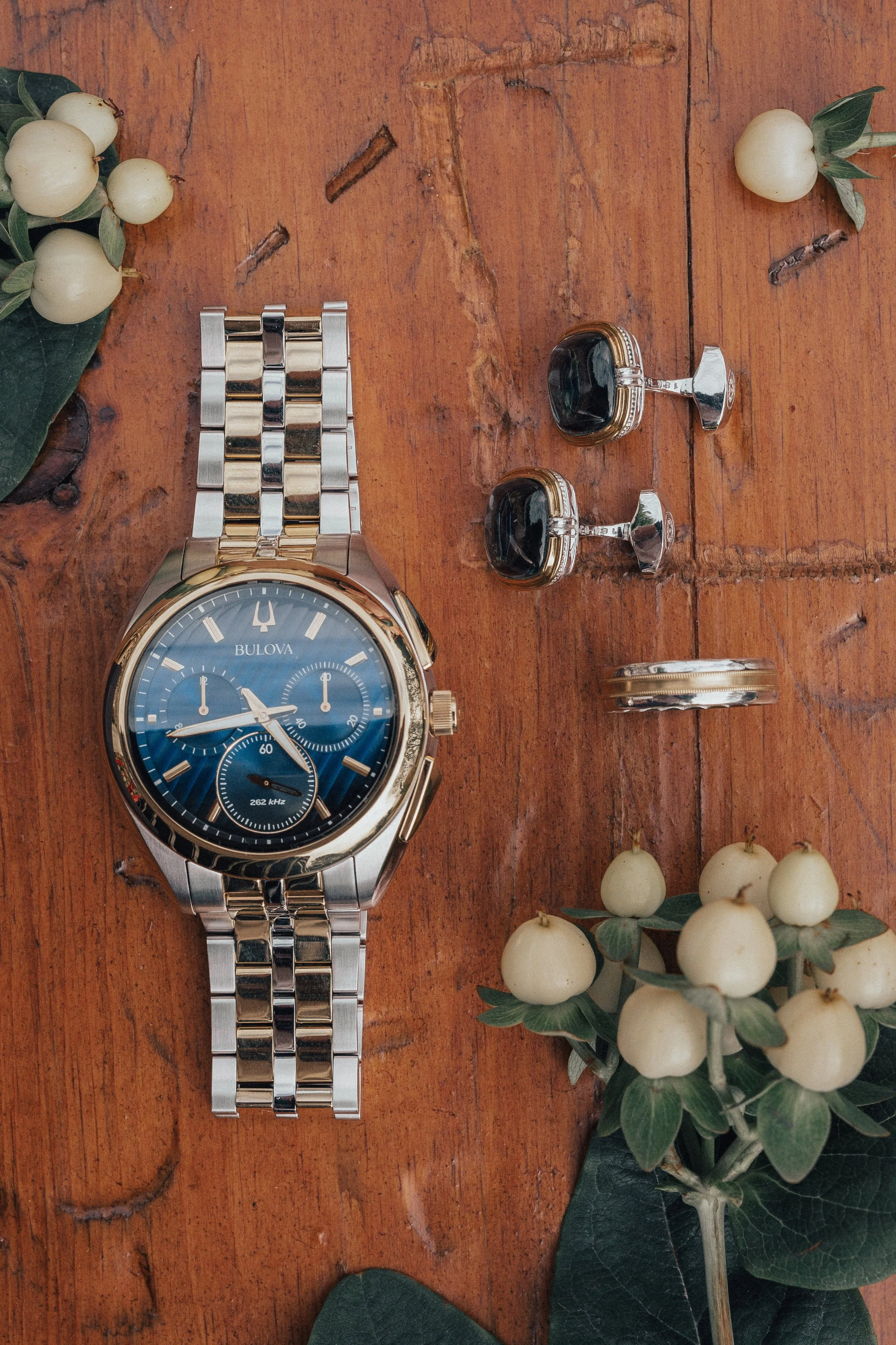 Flat lay with groom's accessories, watch, cufflinks, wedding band, silver and gold, wedding design, modern design