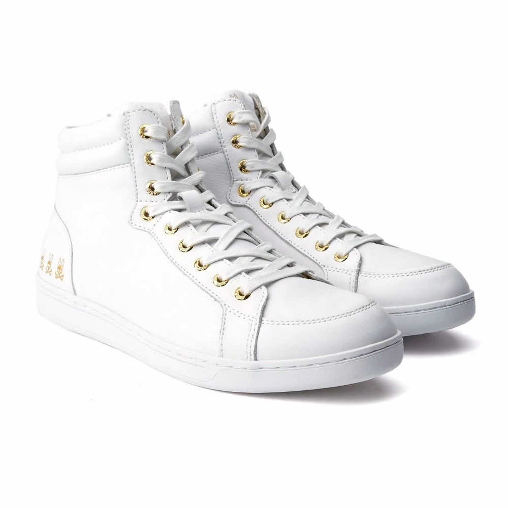 Pair of white high-top sneakers with gold eyelets and white laces