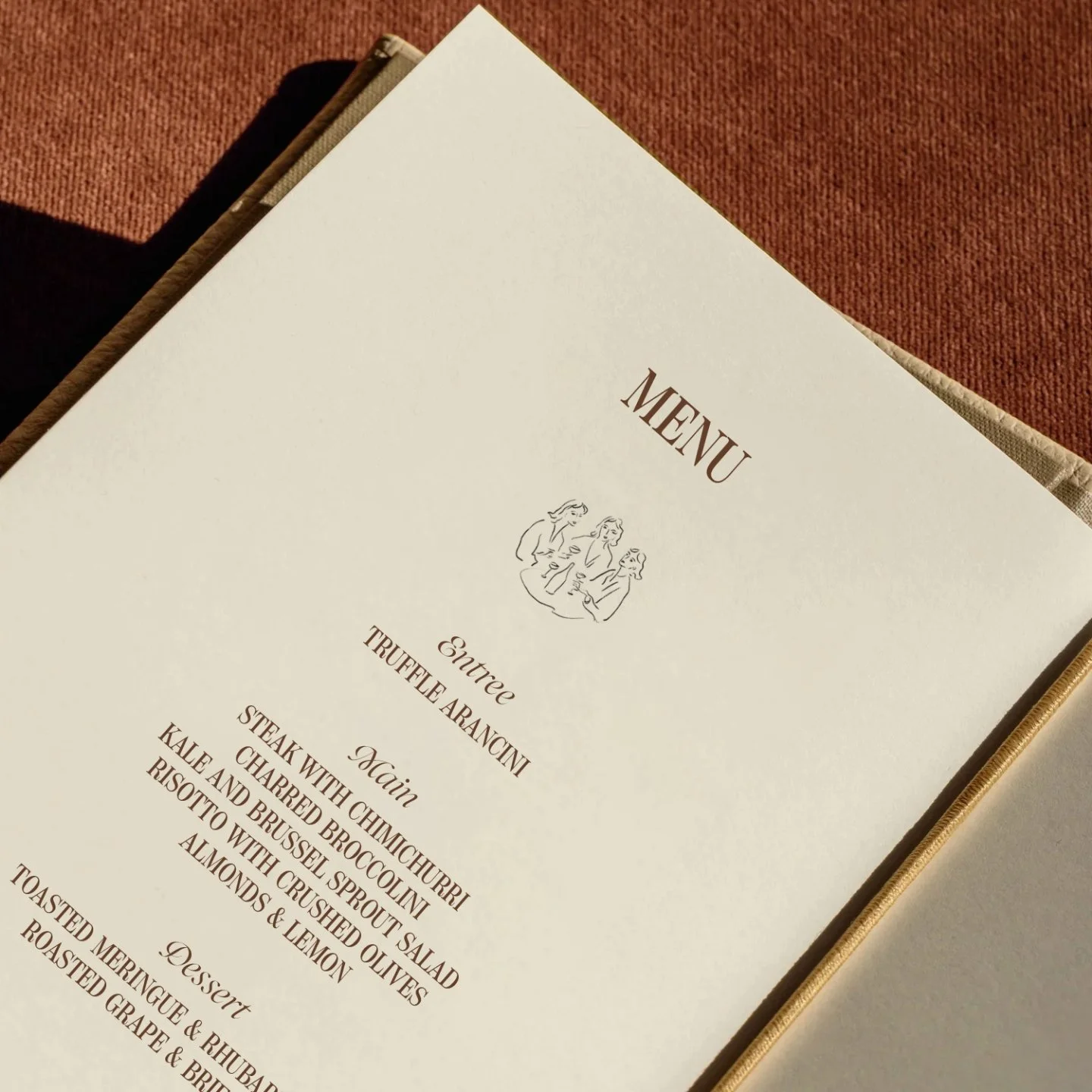 A restaurant menu with the title 'MENU' and a simple illustration of three women holding glasses, featuring an entrée section with truffle arancini, and main courses including steak with chimichurri, cauliflower, charred Brussels sprouts, risotto with crushed olives, almonds, and lemon, and a dessert section with roast mango, roasted grape, and rhubarb.