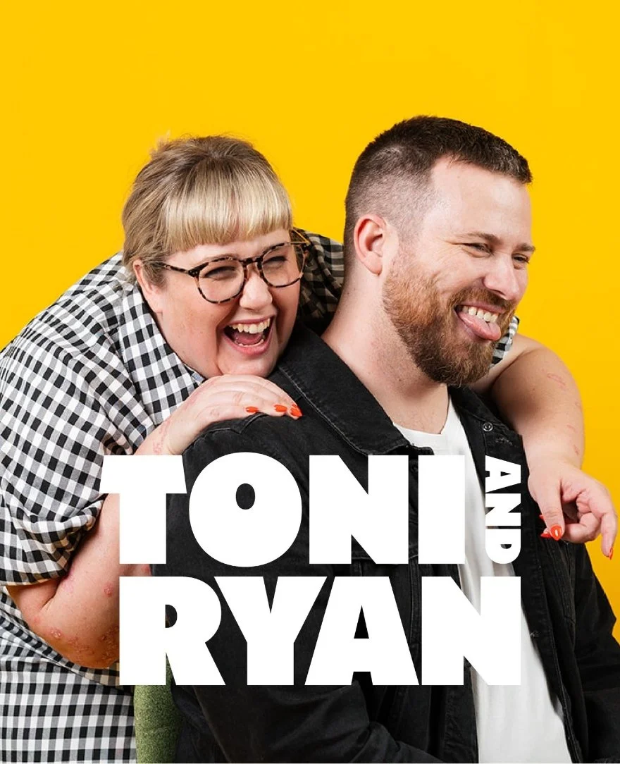 A woman with glasses and blonde hair smiling and embracing a man with a beard and short hair, against a yellow background. The text overlay says "TONI AND RYAN".