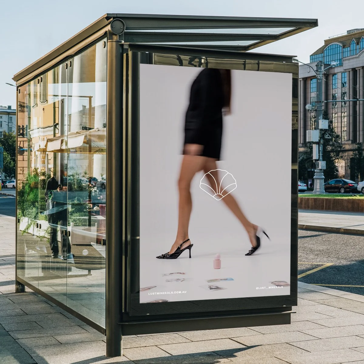 Outdoor bus stop advertisement showing a woman in high heels walking with a white shell logo in the center.