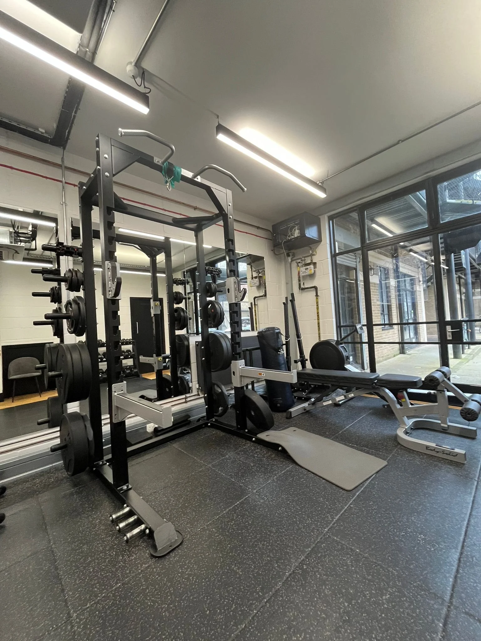 Private personal training studio Islington — squat rack and barbell
