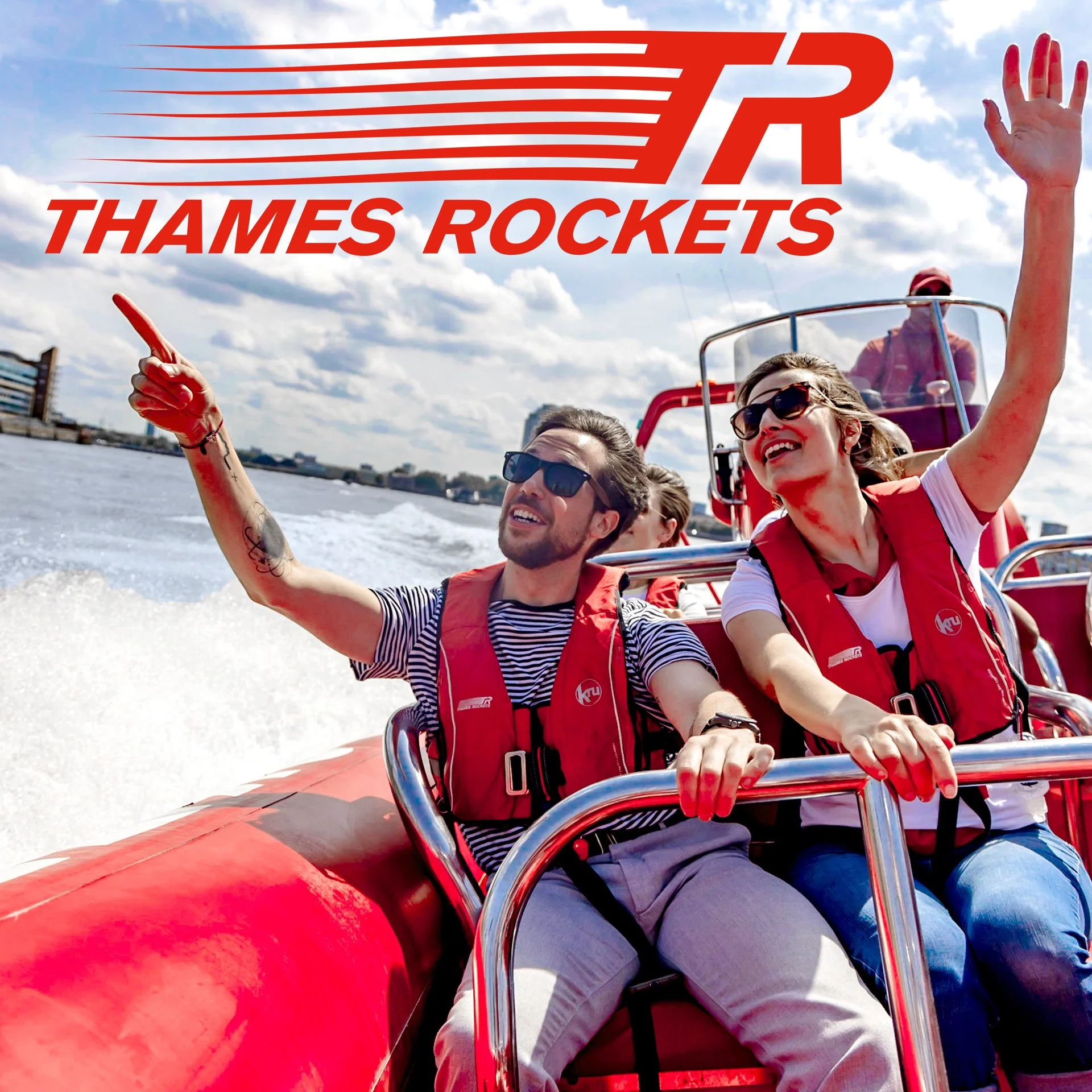 People enjoying a boat ride on the Thames River, with the London skyline in the background, under partly cloudy skies.