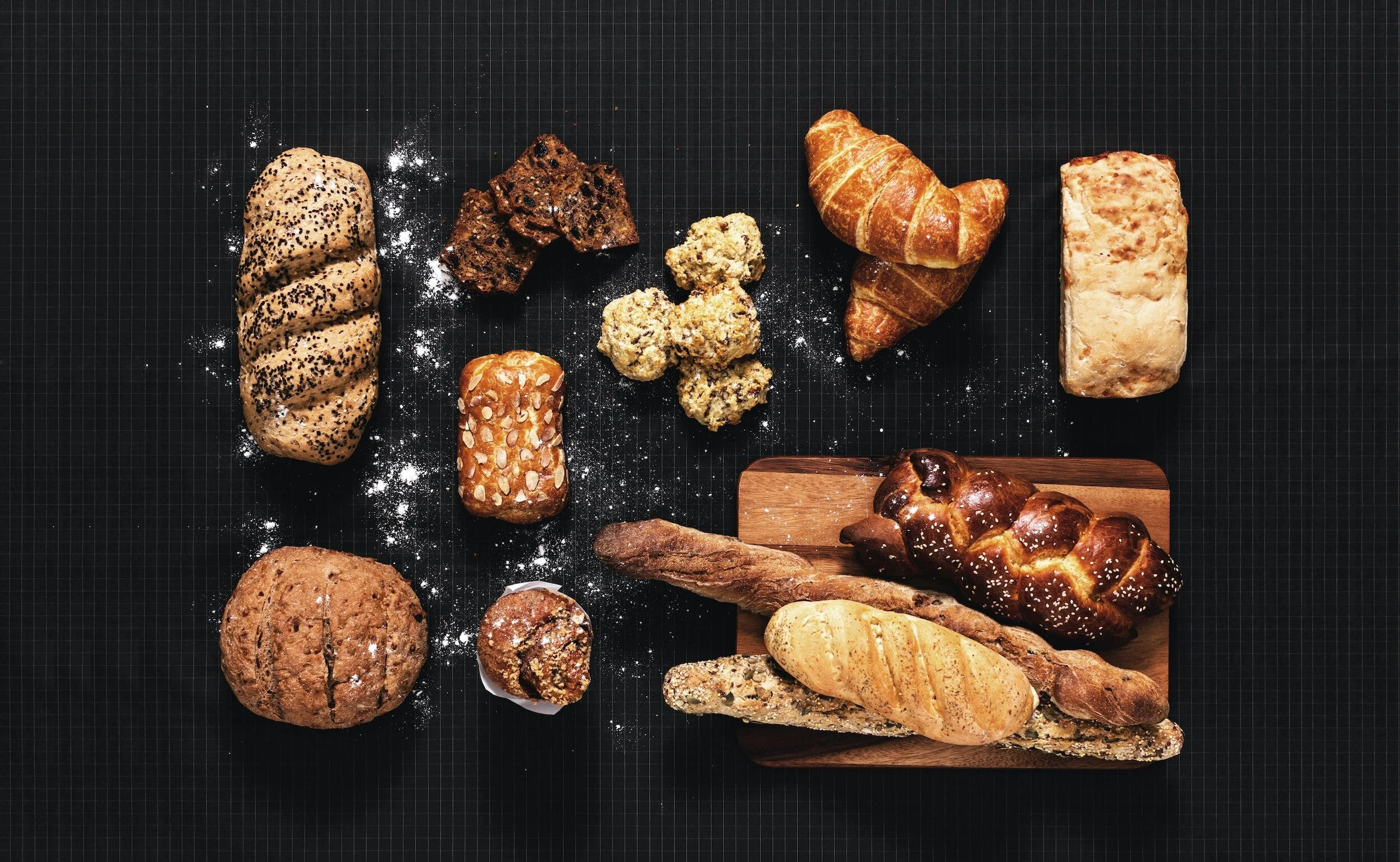 different types of bread displayed on a black surface