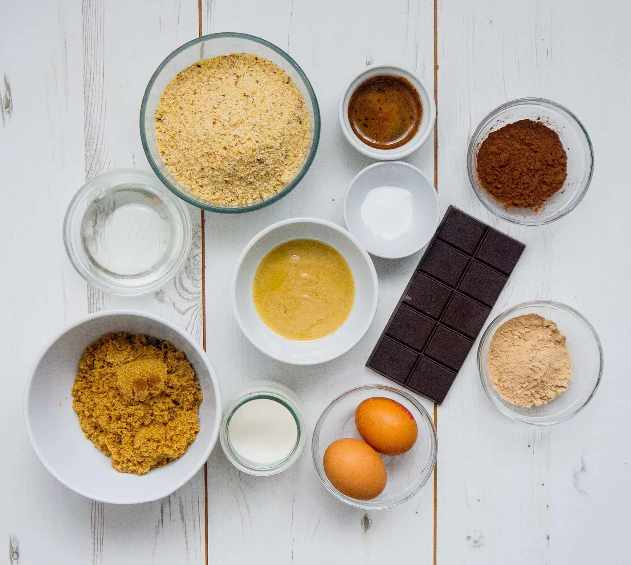 Ingredients for double chocolate chip cookies on a white table