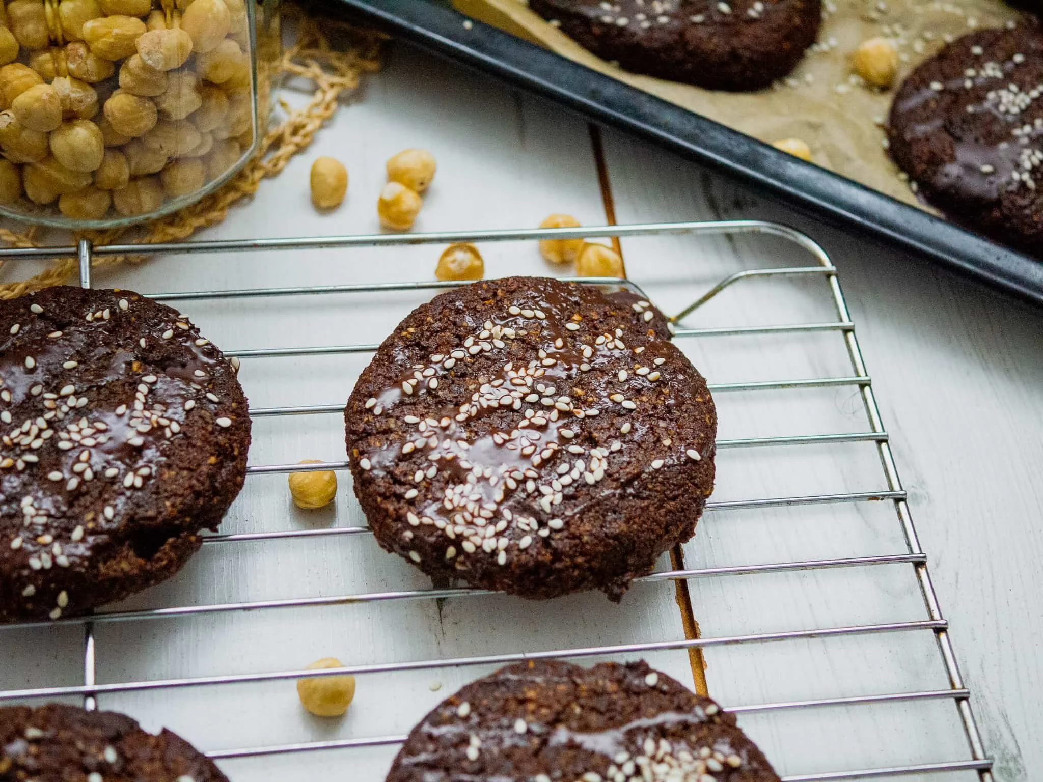 Double chocolate chip cookies decorated with chocolate and sesame seeds