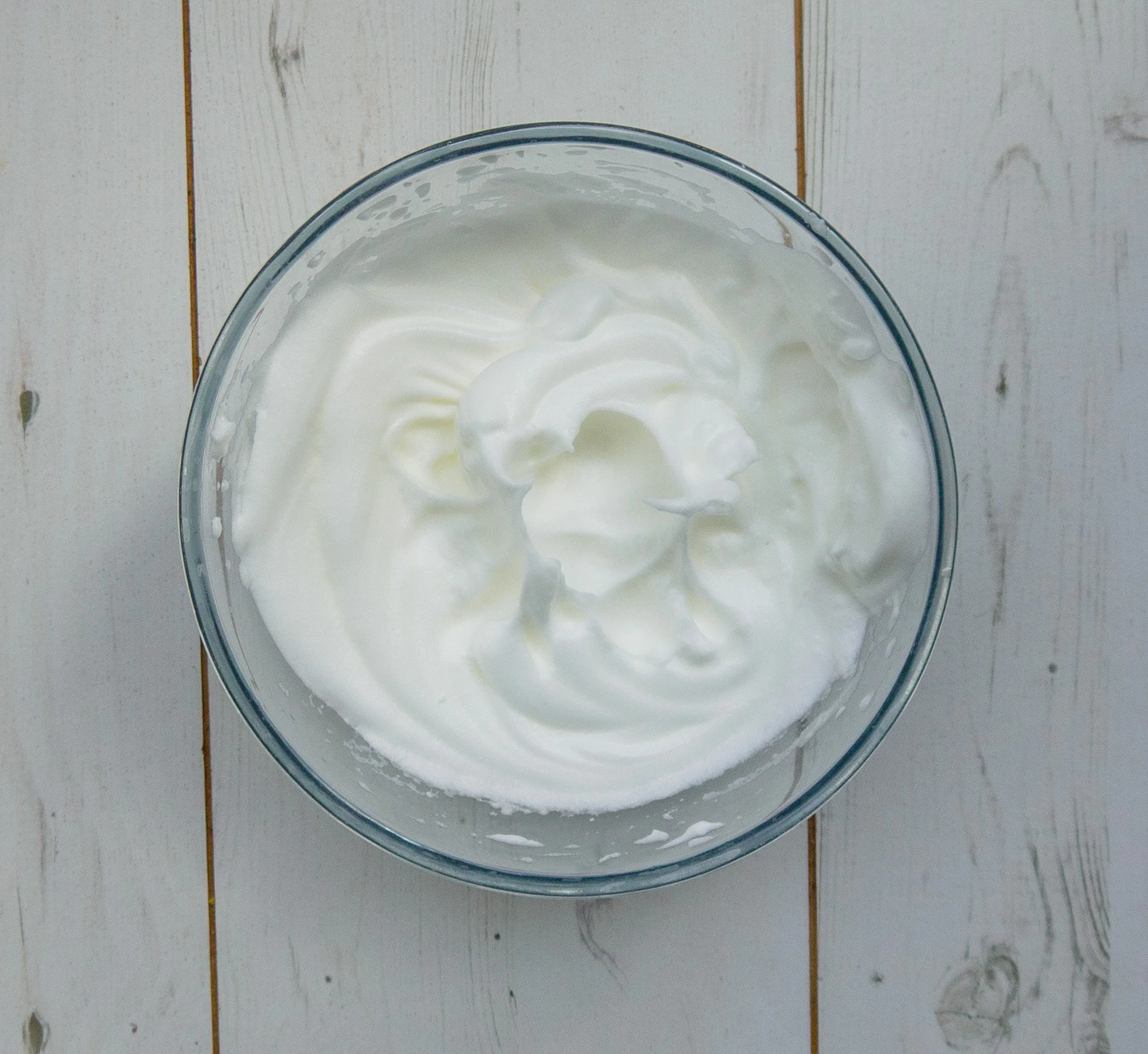 Whipped egg whites in a clear bowl