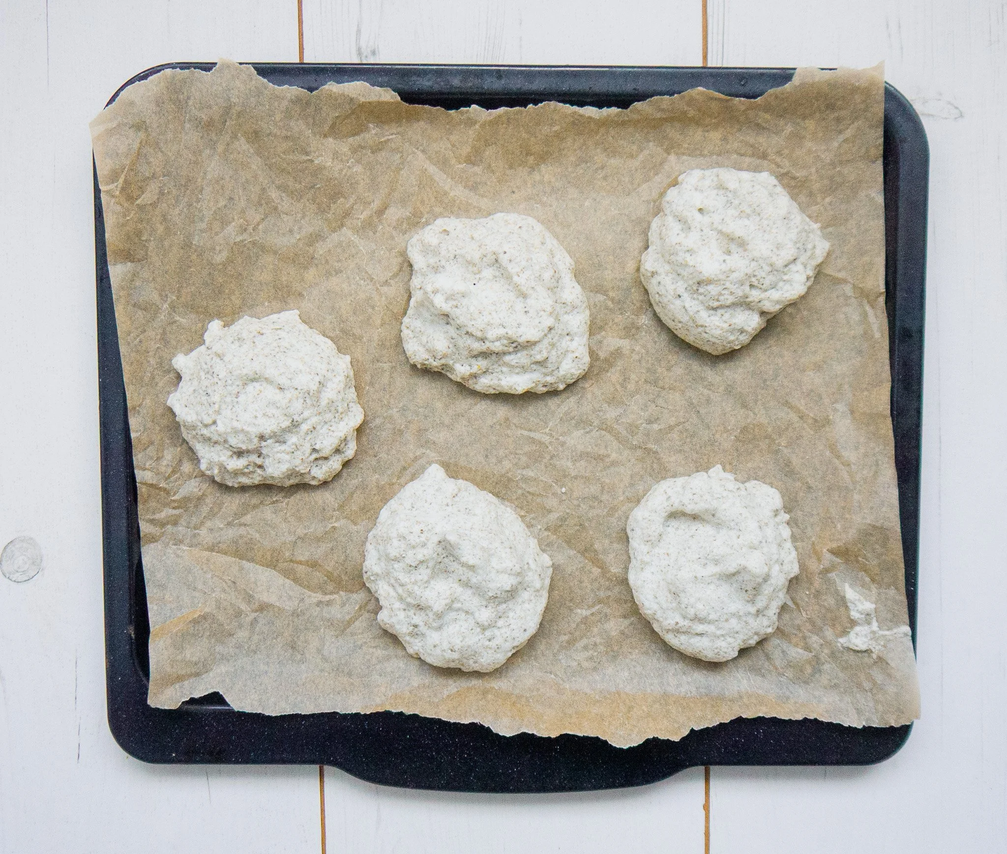 Uncooked cloud bread batter on a baking sheet ready to be baked