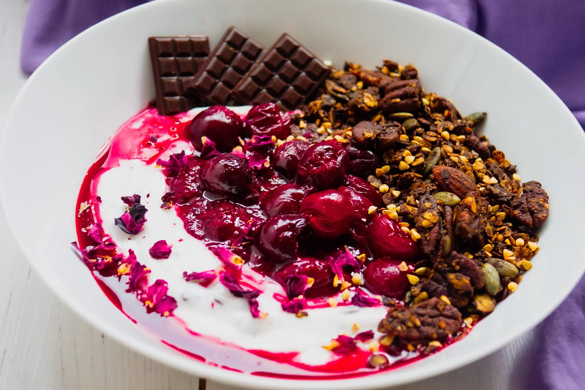 vegan breakfast bowl with chocolate granola and cherries