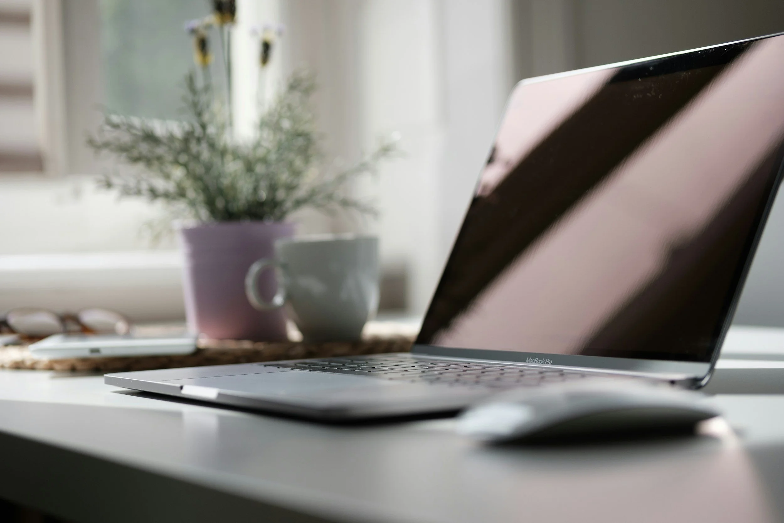 a picture of a laptop on a desk with a mug of tea