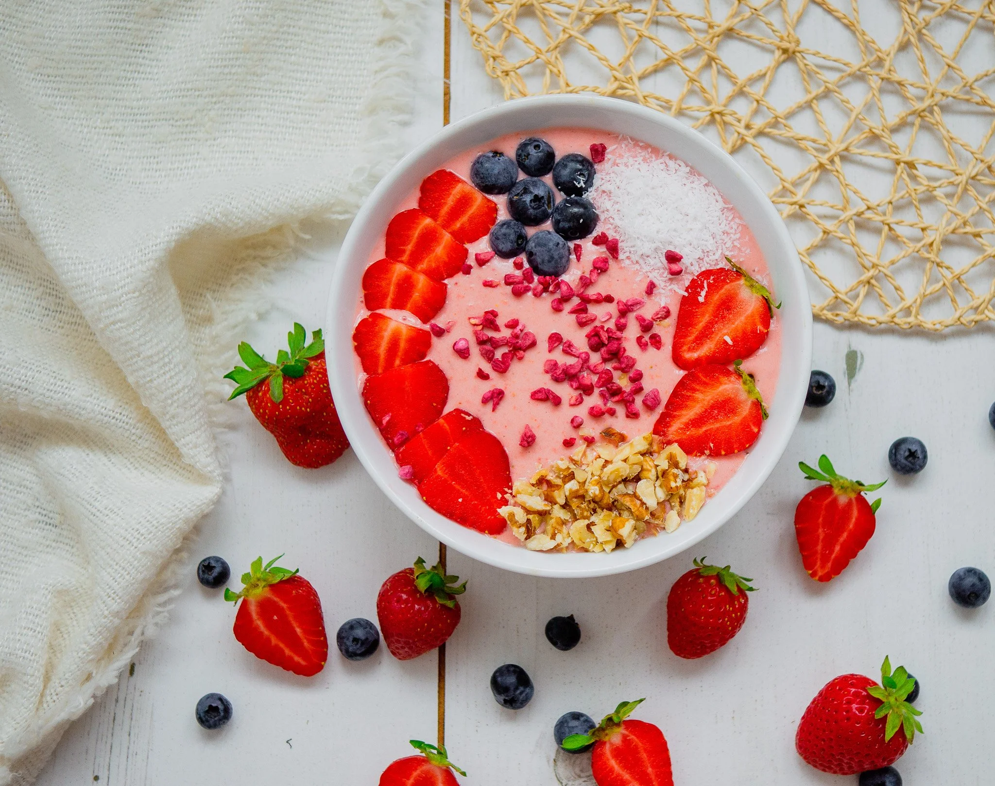 a smoothie bowl with strawberries and blueberrys
