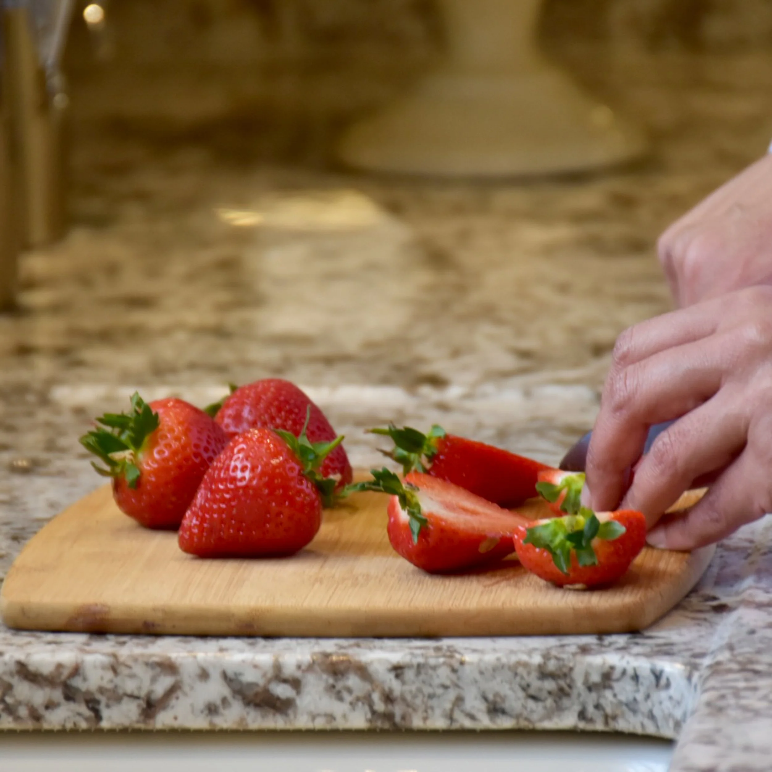 a picture of a chef cutting strawberries