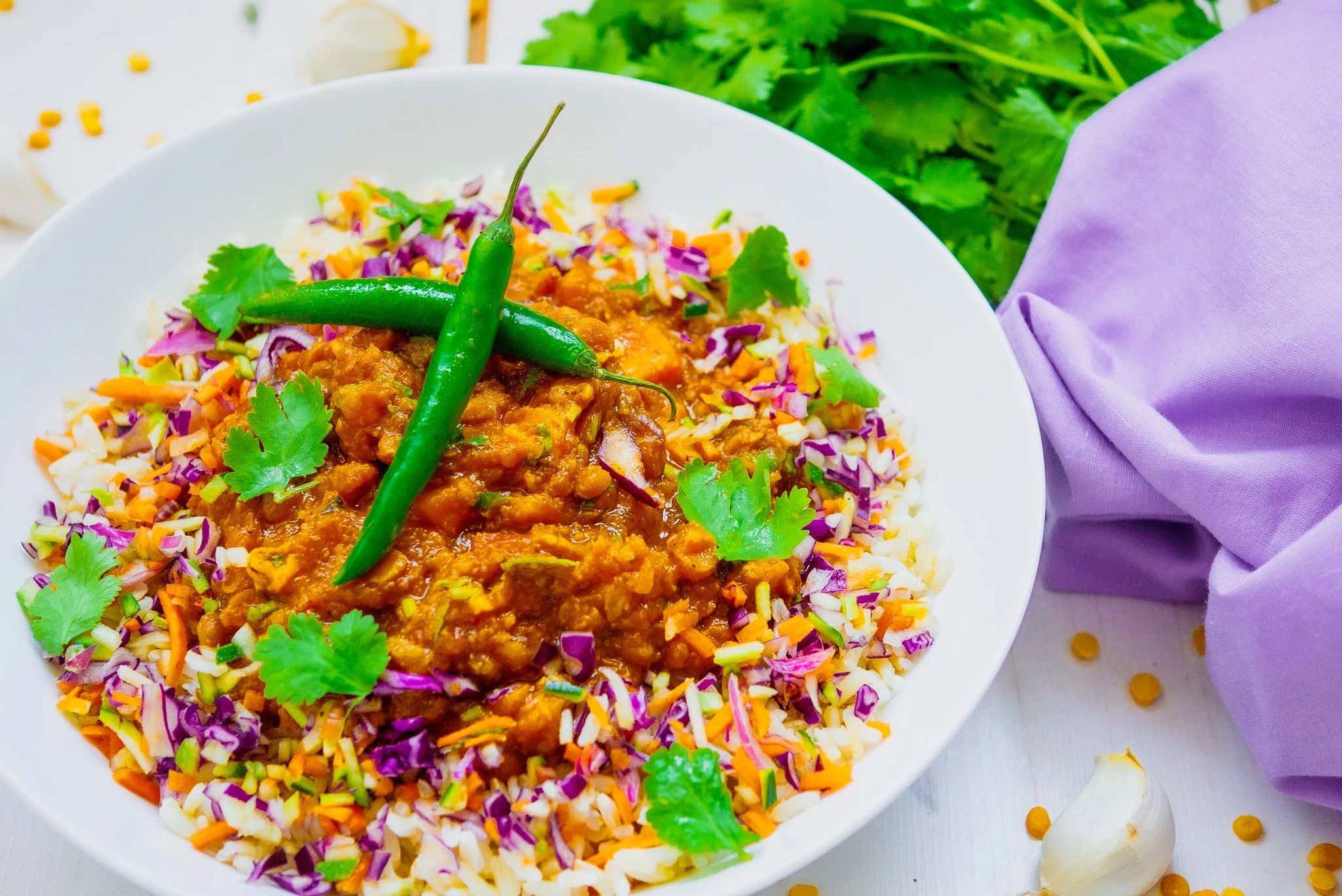 lentil dhal served with vegetable rice served in a white bowl