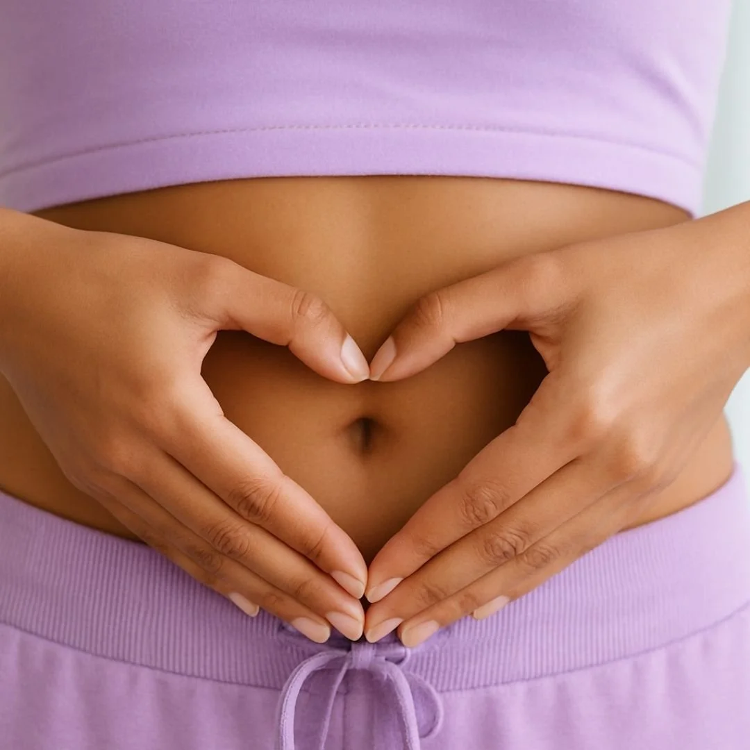 a picture of a ladies stomach with her hands depicting a heart shape