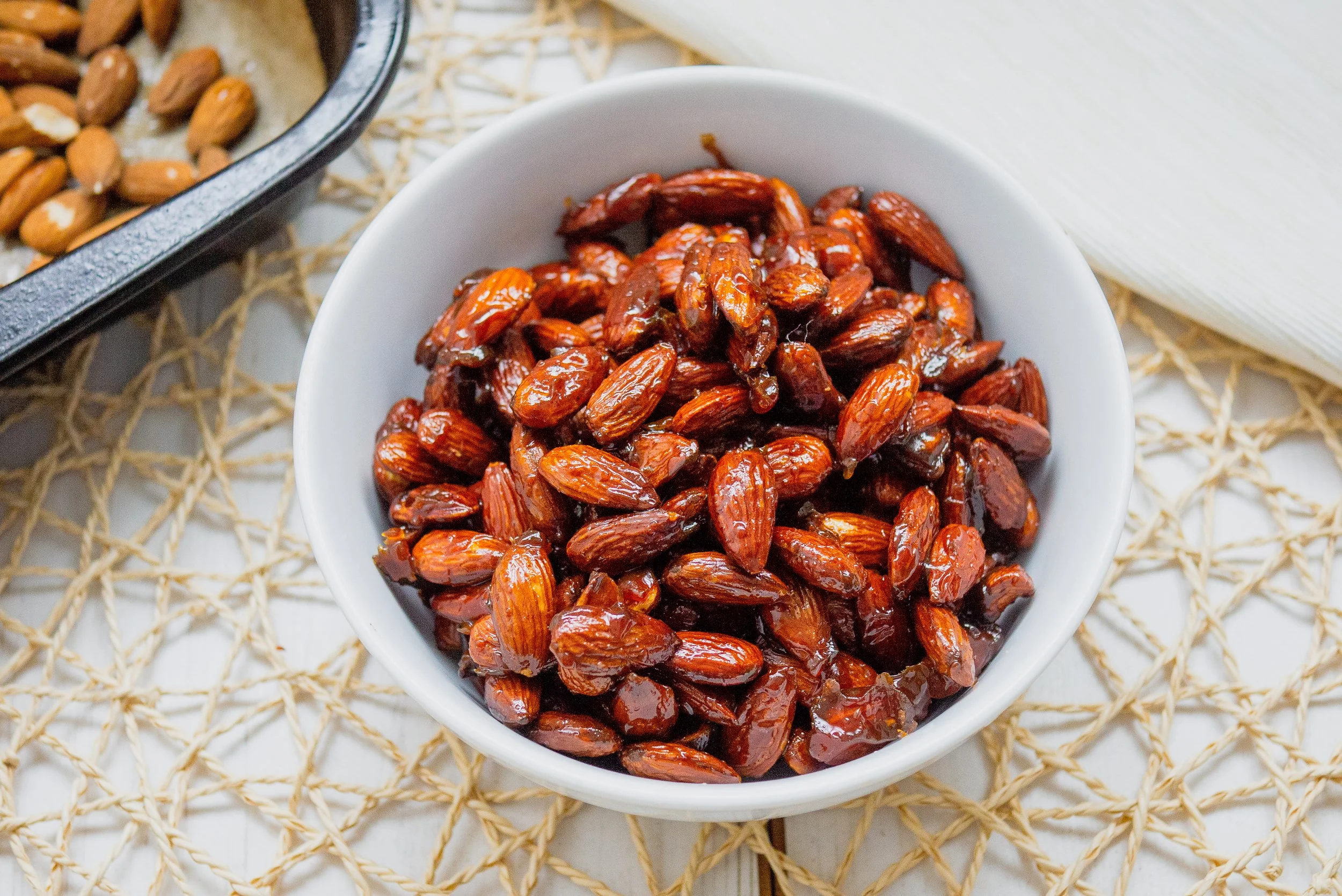 A close up of sticky, spiced cinnamon roasted almonds