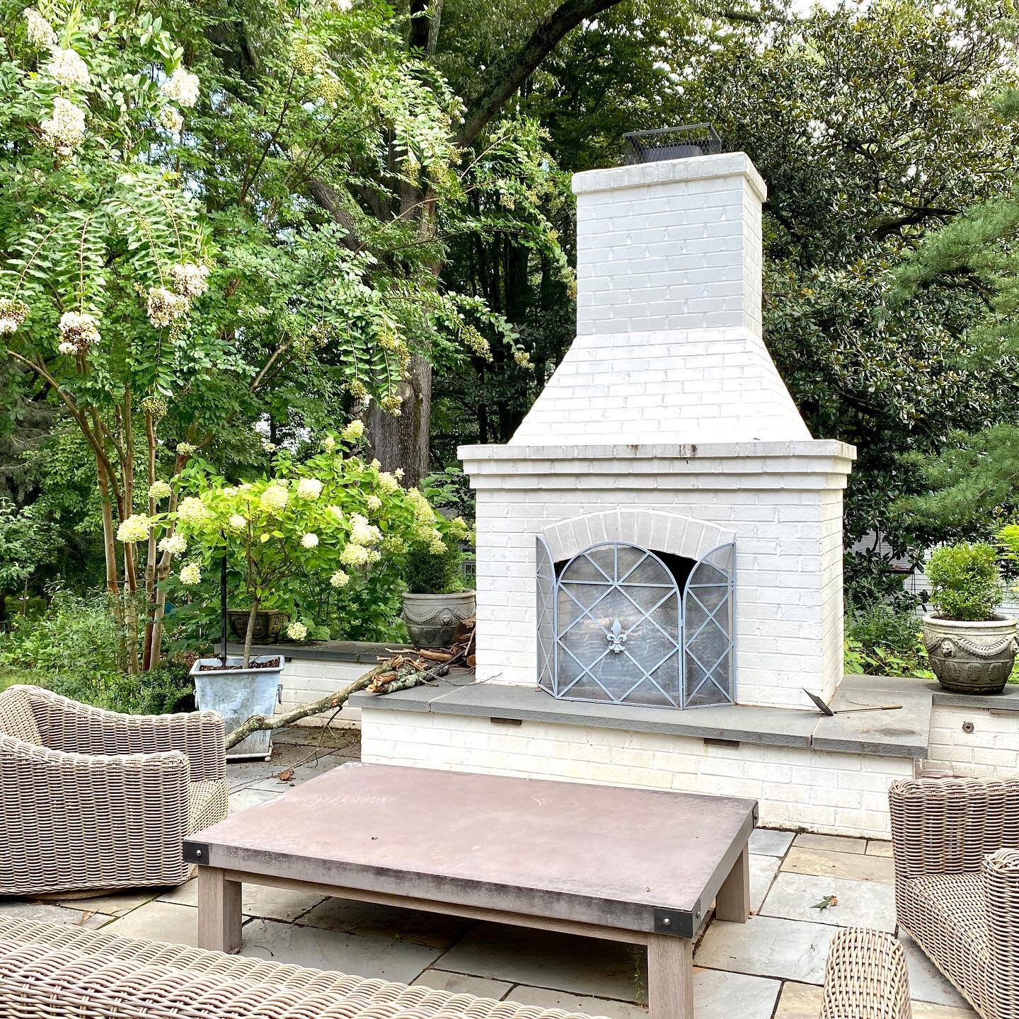 Beautiful afternoon to spend on this patio, complete with a masonry fireplace and covered dining area. ↩️ Swipe for before.
