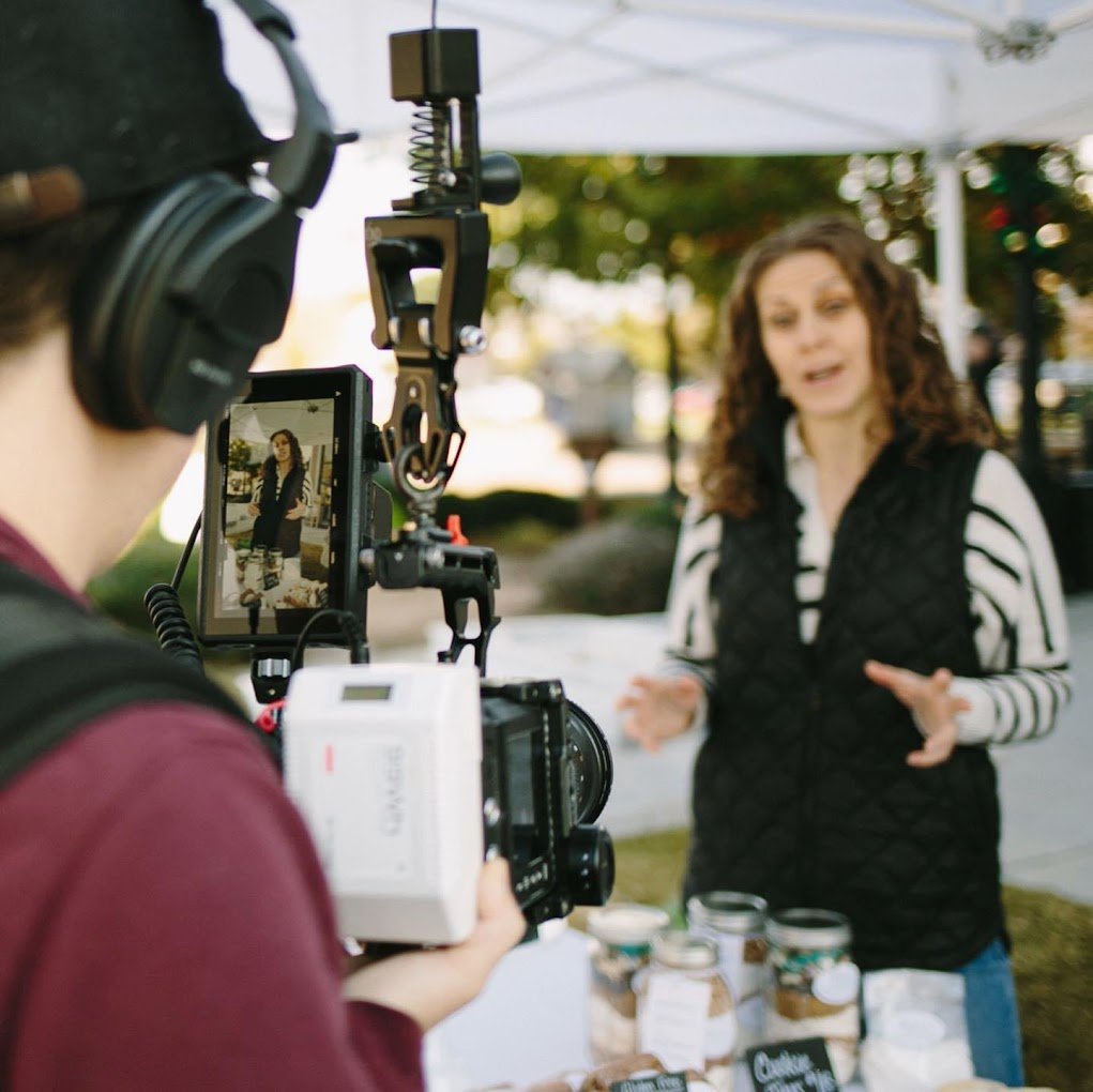 Woman giving instructions to the camera at the Coppell Farmers Market