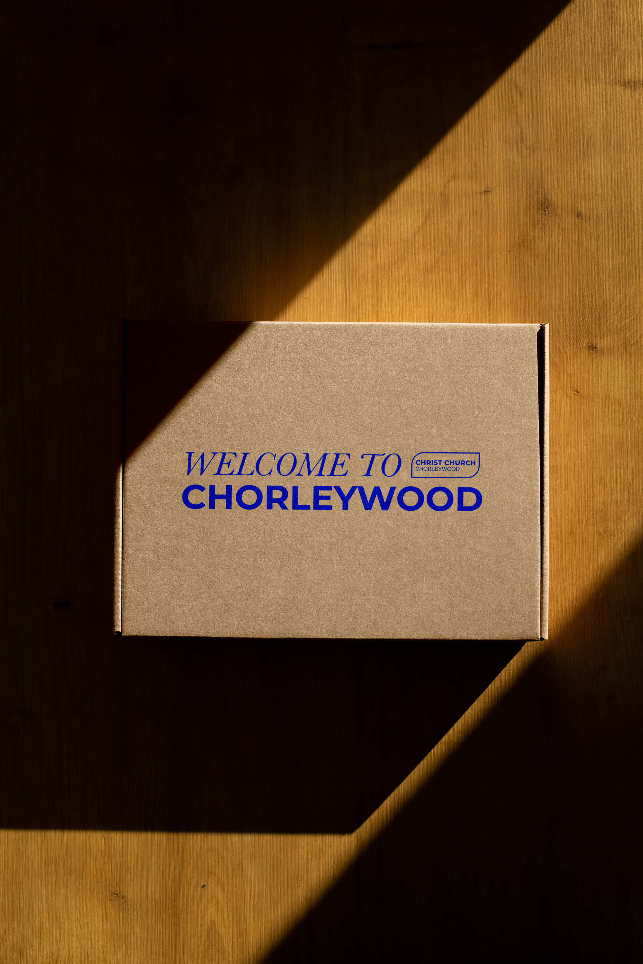 CCCW OUTLINE Paper Box on Wood Floor Mockup.png
