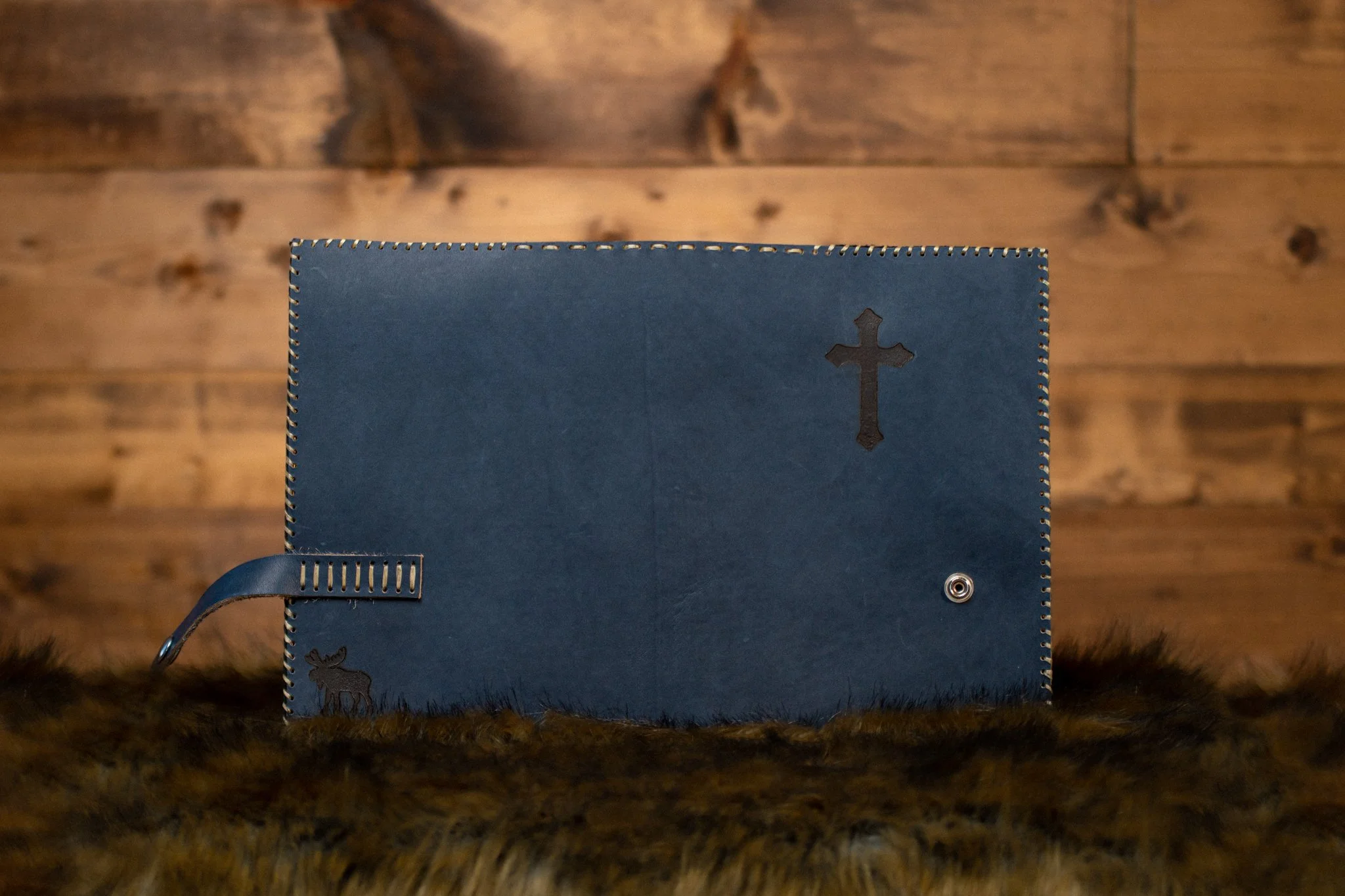 open leather cover in charming blue with cross and moose