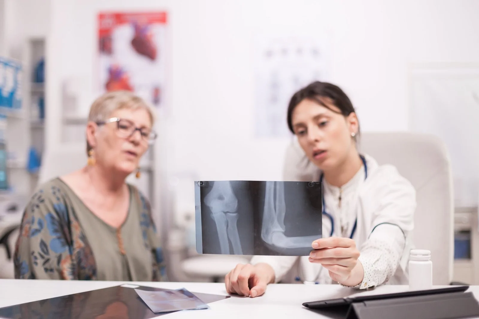 Doctor reviewing an X-ray with an older woman during a consultation