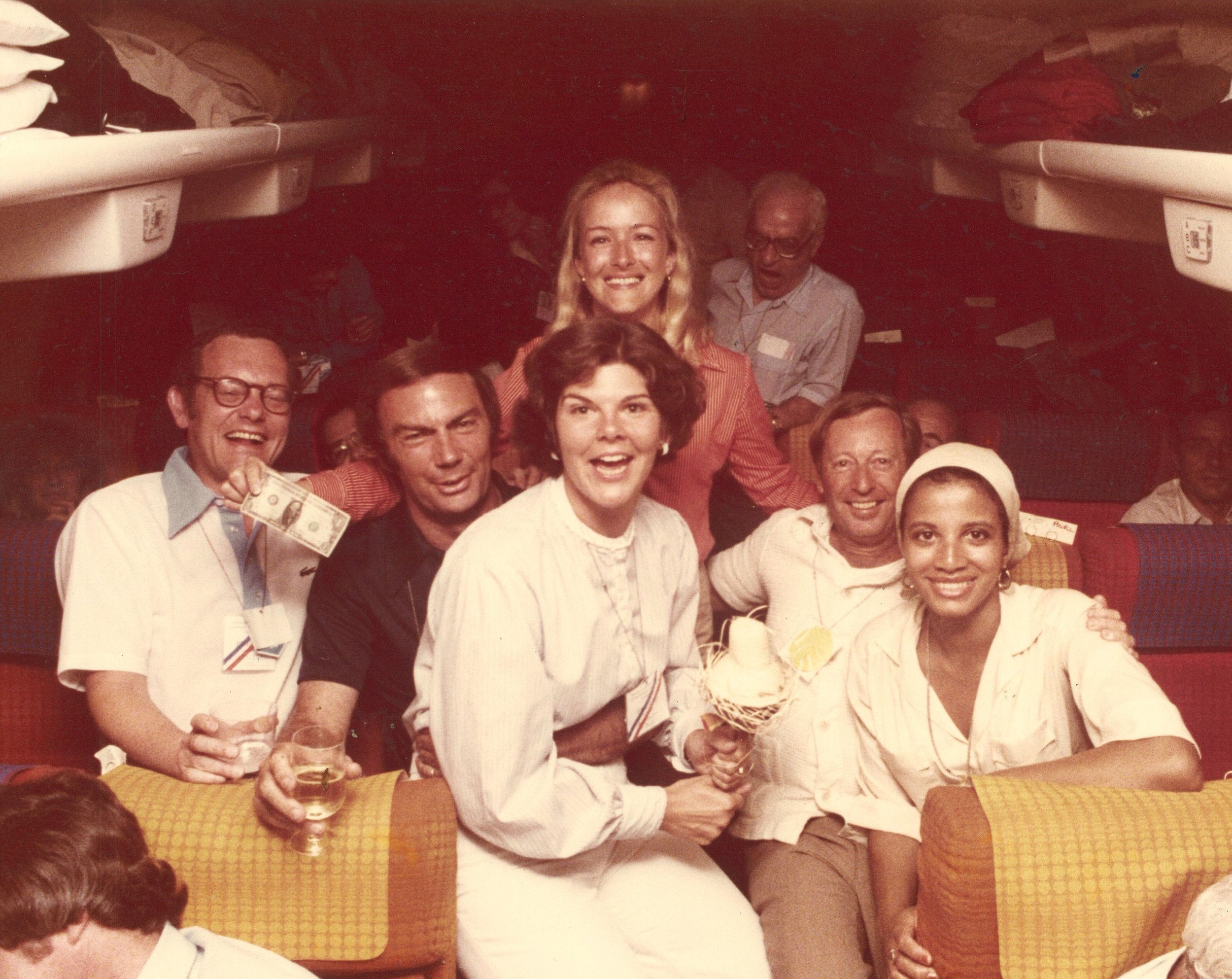 Woodruff on airplane with press, including Sam Donaldson