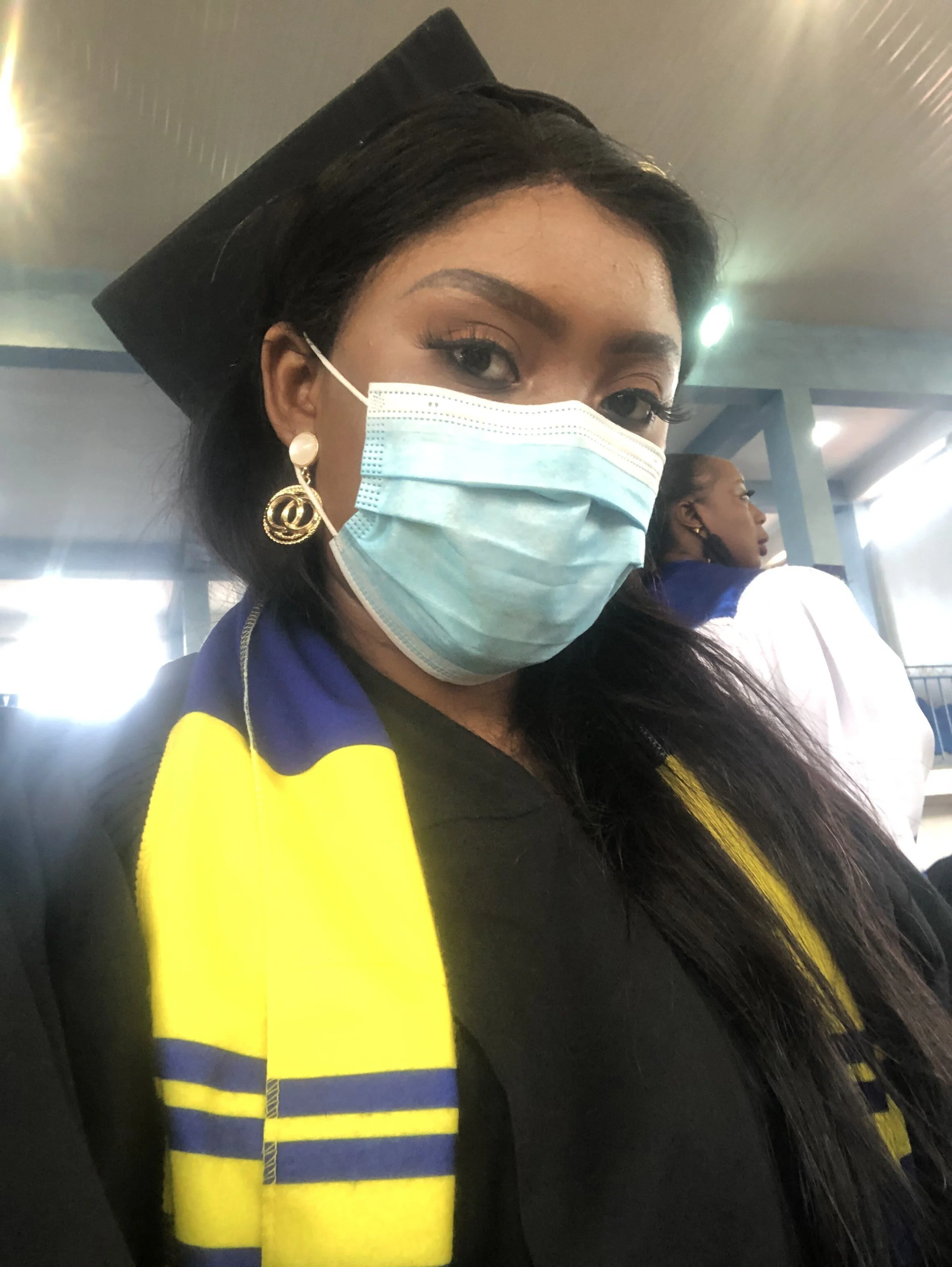 Davidetta Z. Forkpah poses for a portrait at her graduation on Jan. 29, 2021, in Monrovia, Liberia. The mask is part of the university’s pandemic protocols.