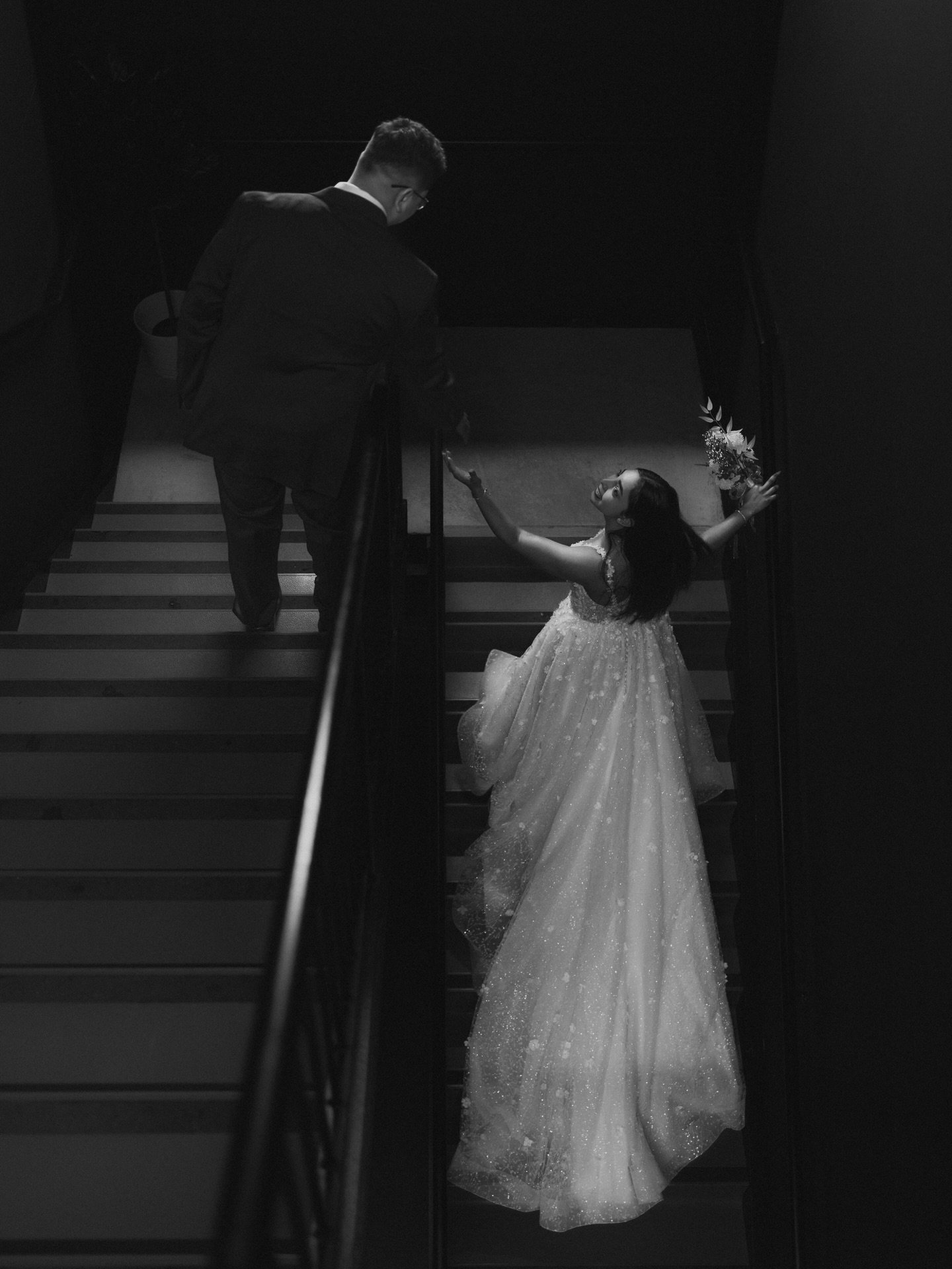 I&rsquo;m drawn to moments that feel quiet and intentional. Strong contrast, deep shadows, the movement in her dress, and that look up at him. It all comes together in a way that feels timeless without trying too hard.

#WinnipegWeddingPhotographer
#