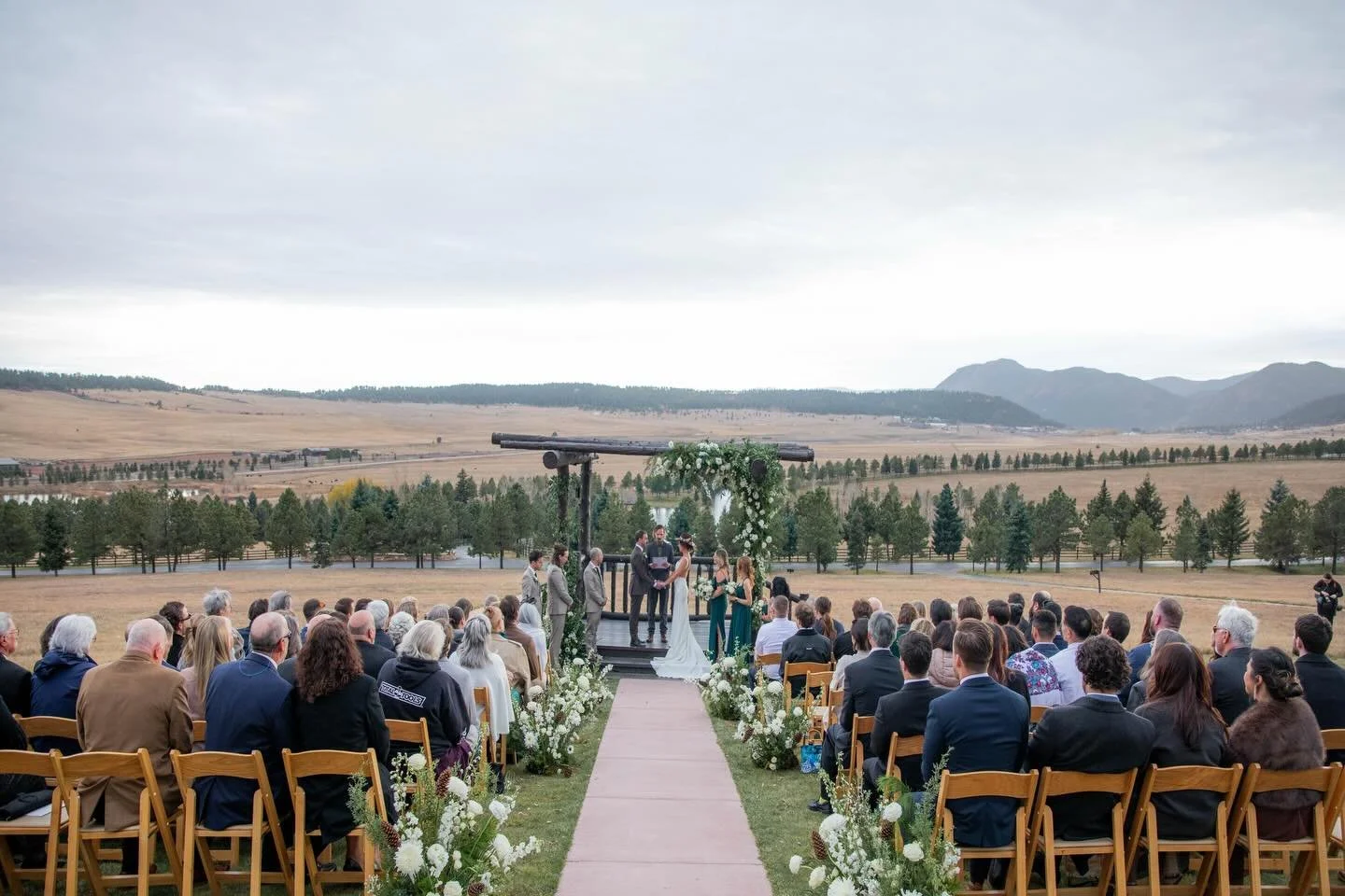 A refined white-and-green palette grounded the design&mdash;clean, textural, and quietly luxurious. Sculptural blooms and layered foliage set an editorial tone, while restrained touches of pinecone introduced a subtle Colorado nod without overpowerin