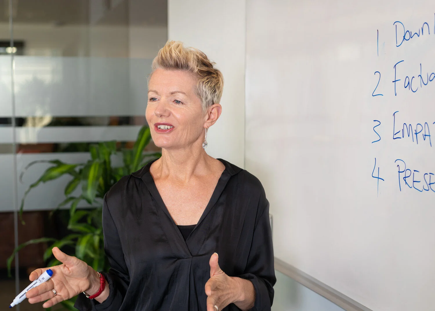 Deb presenting a workshop in front of a whiteboard