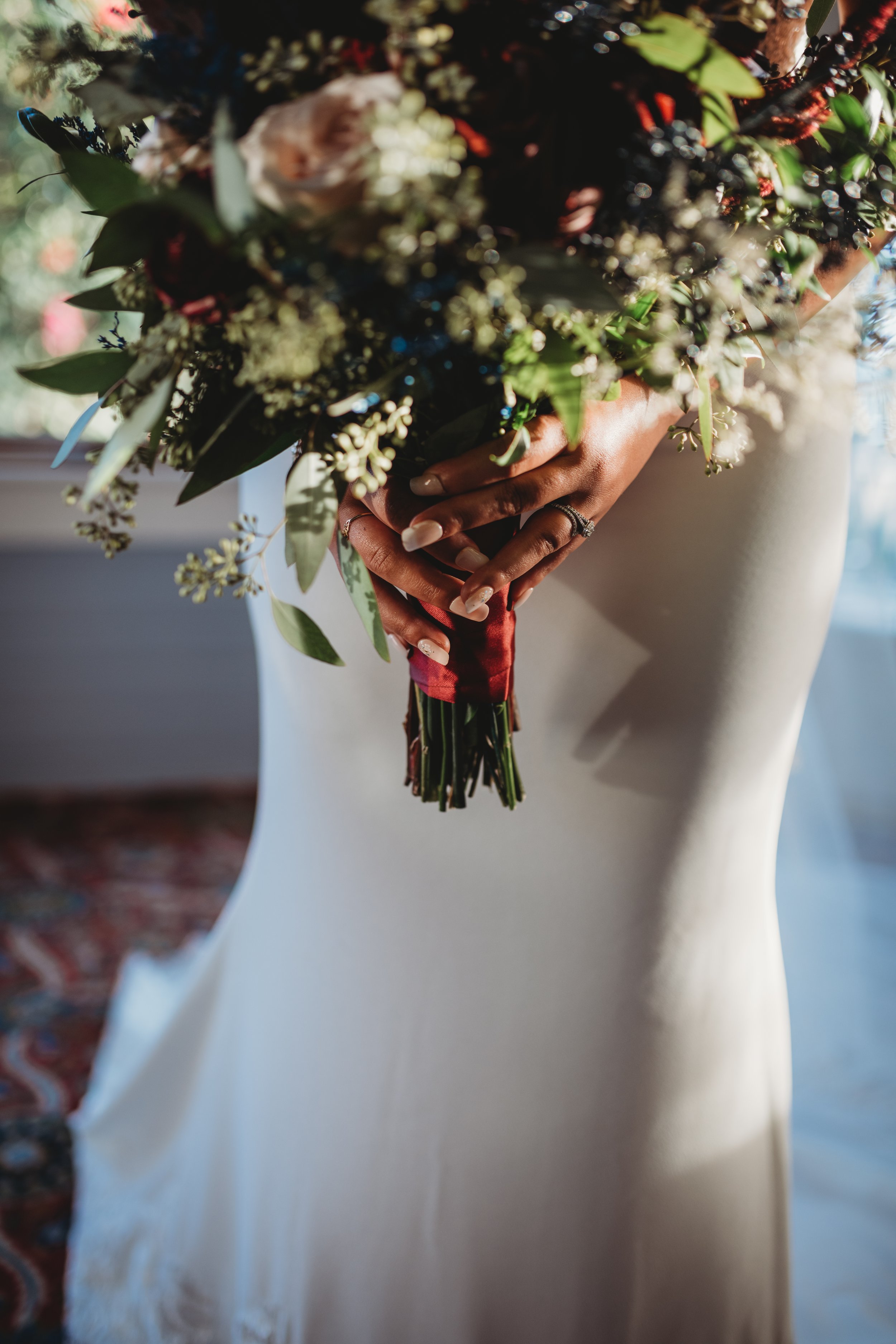 Bride in white dress holding bouquet of flowers