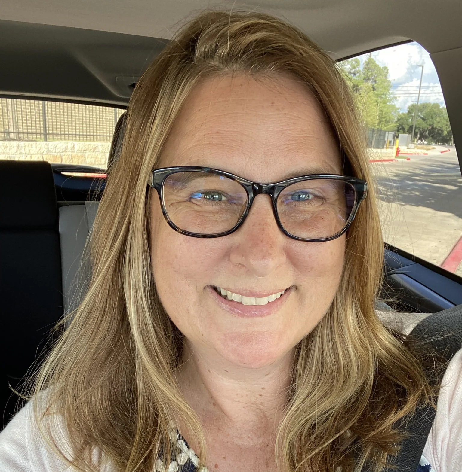 Smiling woman with eyeglasses on.