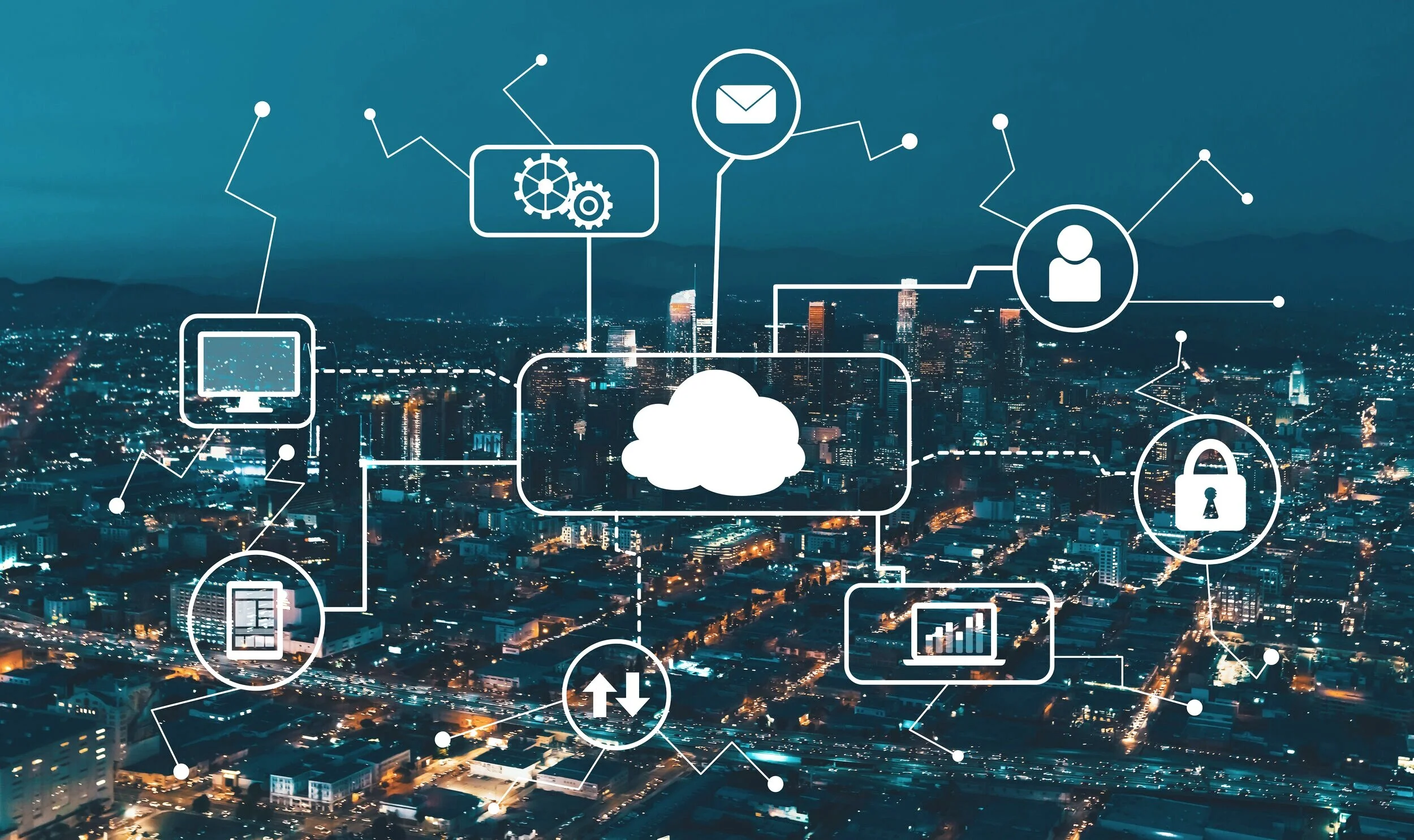 City skyline at night with digital icons and lines representing cloud computing and connectivity overlayed.