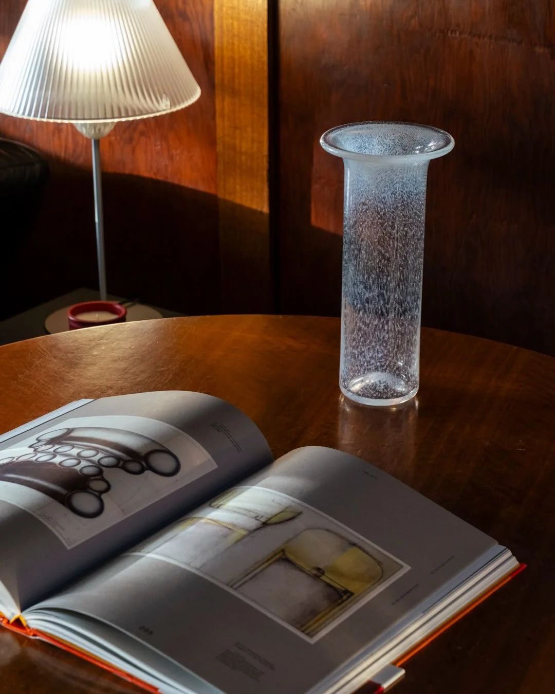 Speckled Glass Vase, signed KG, 1988

This very elegant mouth-blown glass vase has a ghost-like quality thanks to the tiny flecks of opaque white that are stippled throughout and denser at the rim &mdash; looks stunning against a dark backdrop. Signe