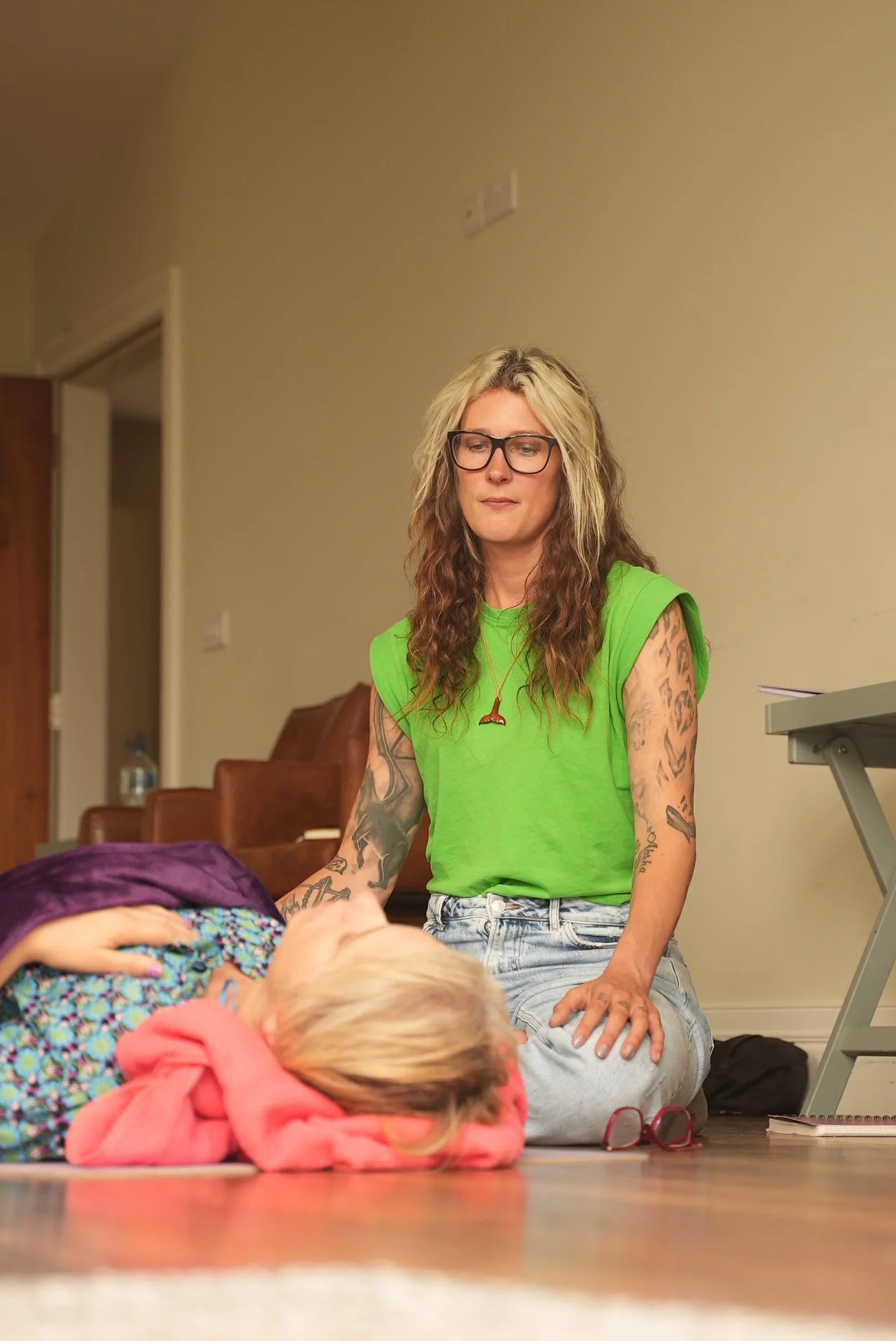 Cornelia facilitating breathwork and attending to a client