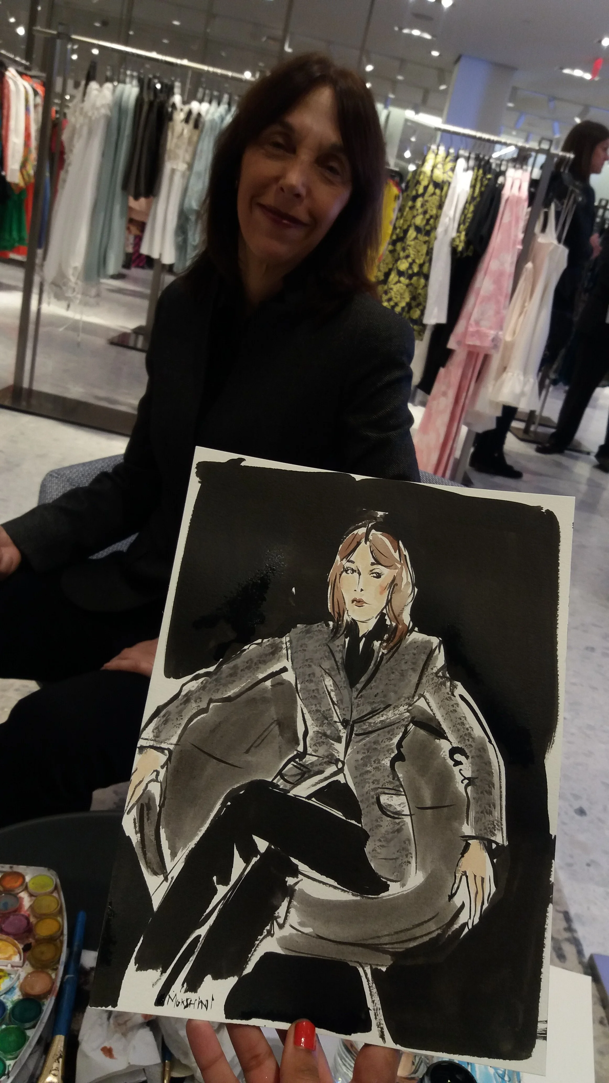 Guest with Mokshini's sketch of her at Neiman Marcus' Hudson Yards launch