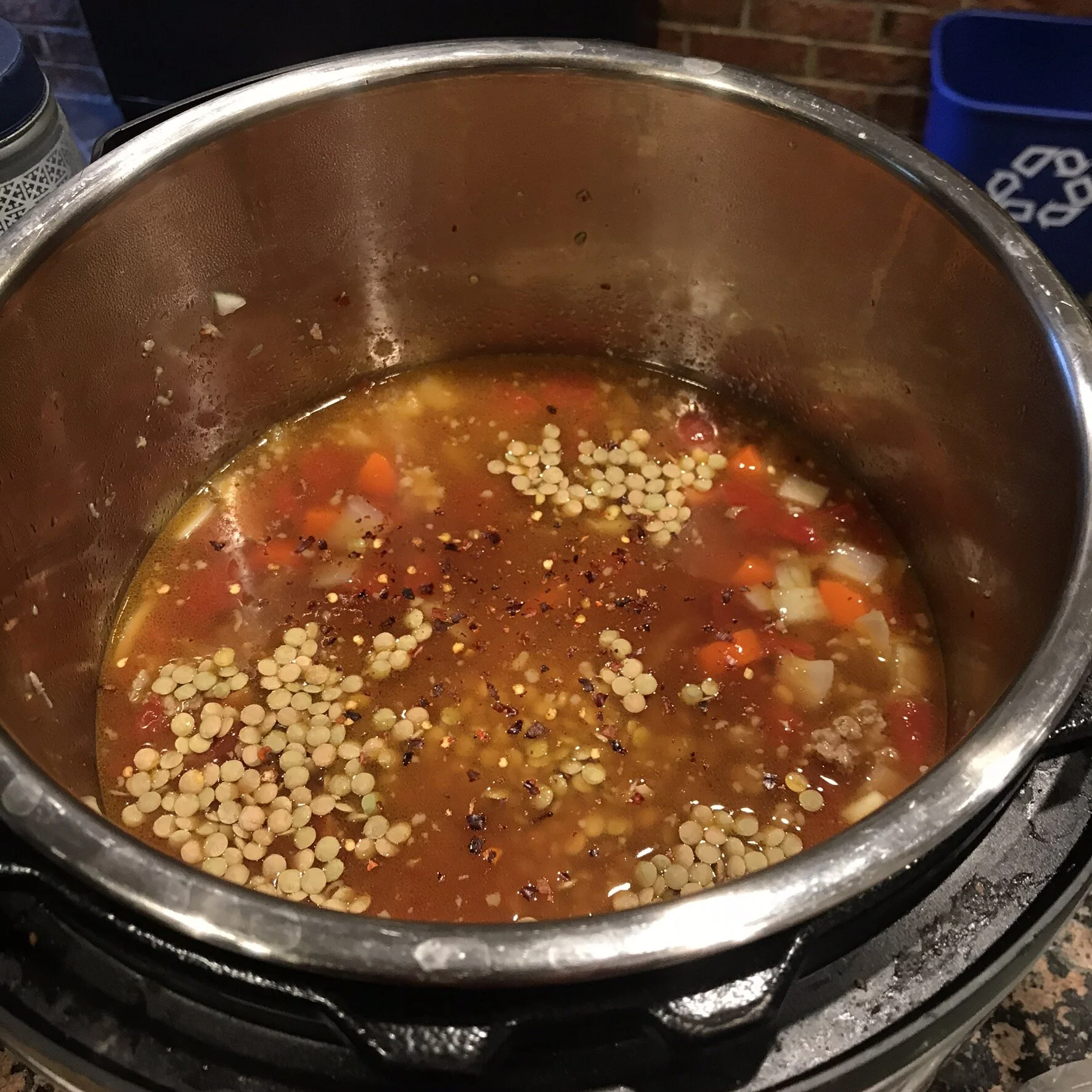Add stock, lentils, tomatoes