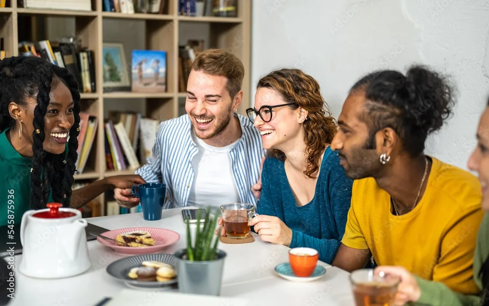 happy customers sitting in a cafe drinking tea