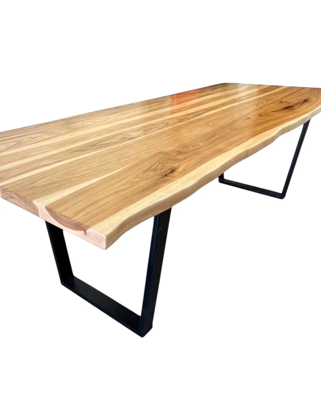 Wooden table with a live edge and black metal legs