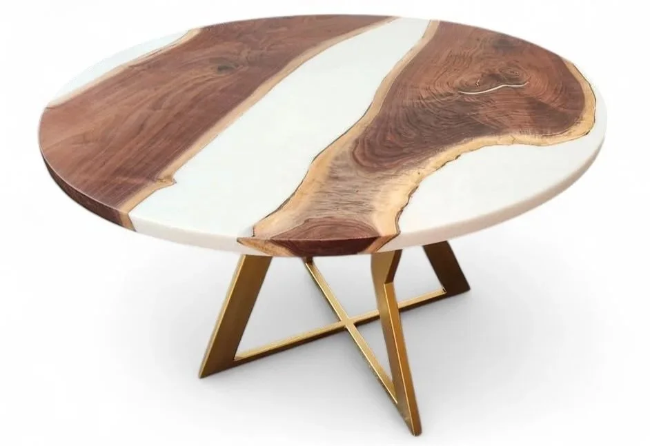 Round wooden table with a natural, live edge and gold metal legs.