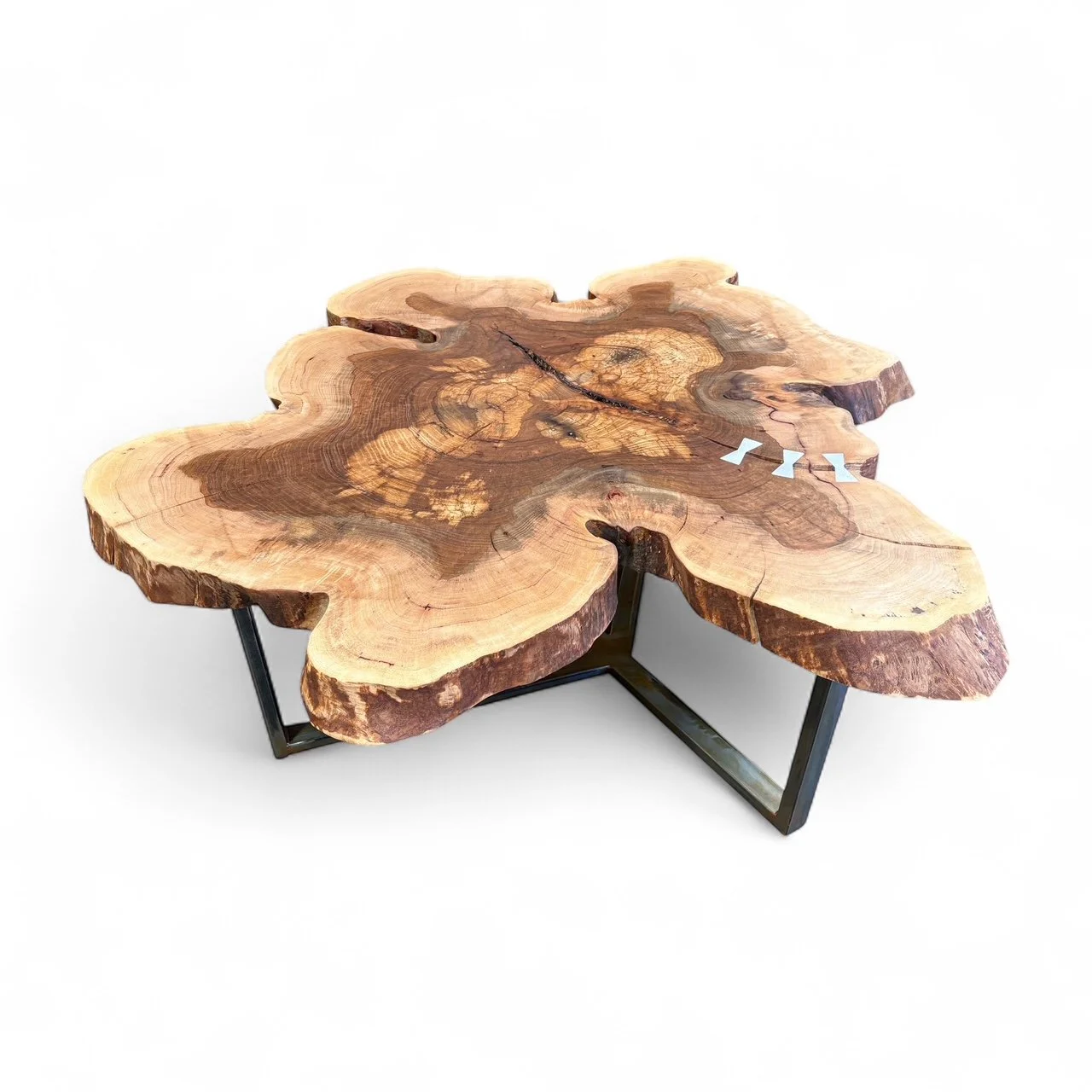Live edge wood slab coffee table with metal legs.