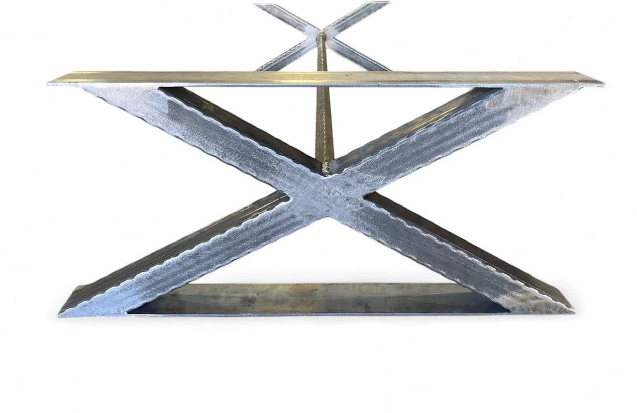 Metal table frame with a rectangular top and crisscross support beams, unfinished and shiny metallic surface.
