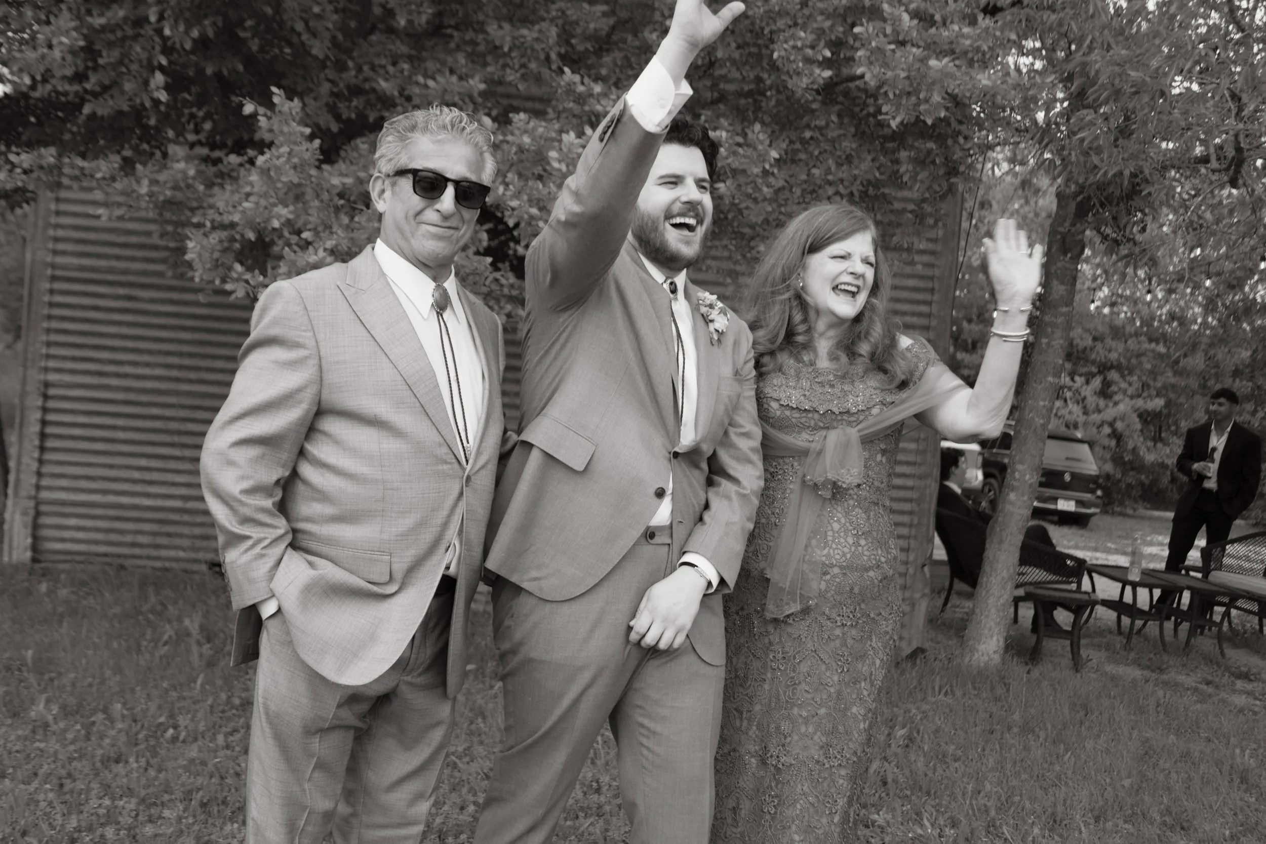Groom photographed on his wedding day with his parents at Camino Real Ranch in Dale, Texas