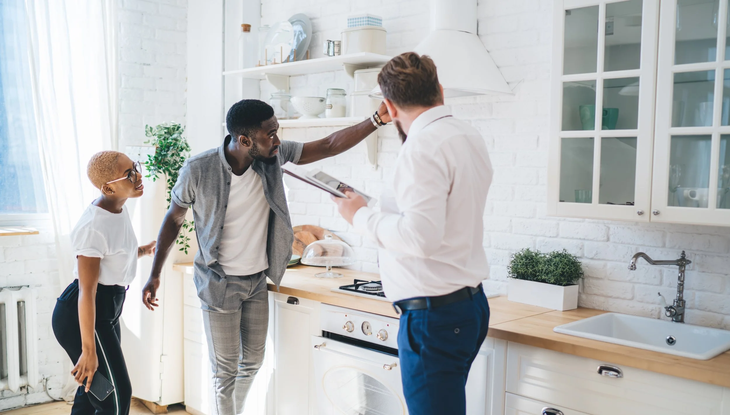 Home buyers touring a kitchen with a Power Properties Realtor during the home buying process.