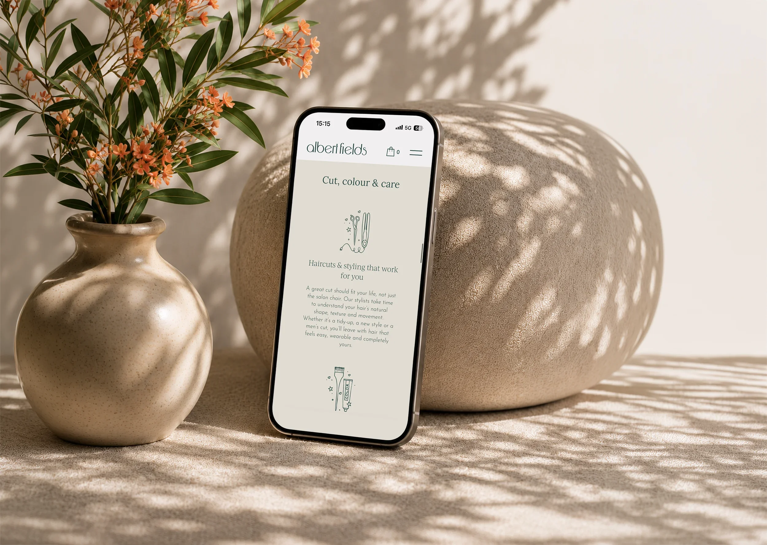 Albert Fields salon website shown on mobile, featuring the cut, colour and care services page and branded illustrations.